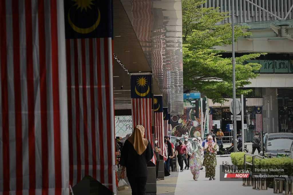 Pedestrians stroll through Jalan Tuanku Abdul Rahman in the capital city of Kuala Lumpur.