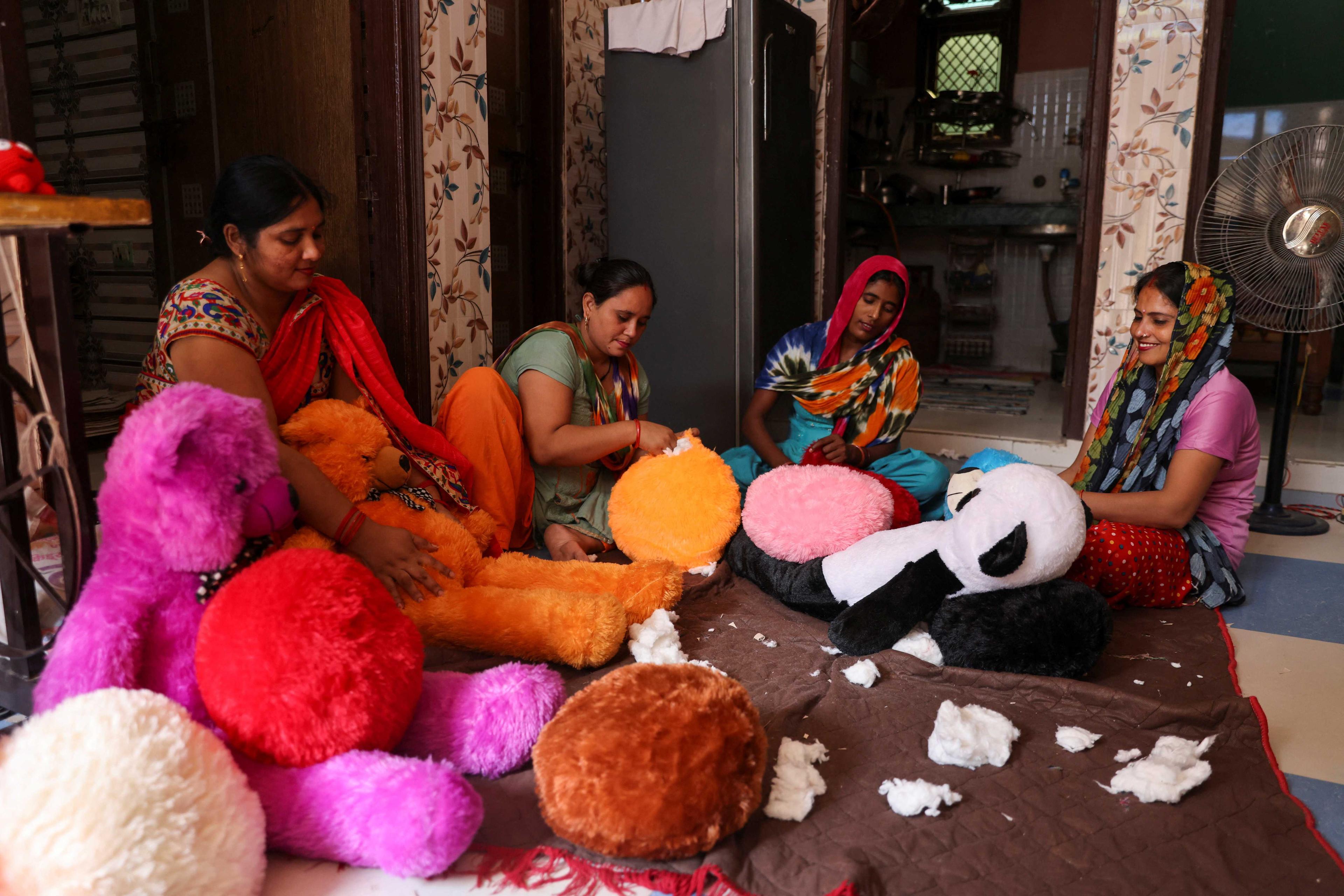 Women workers make soft toys using recycled fibre separated from cigarette filter tips at a cigarette butts recycling factory in Noida, India Sept 12. Photo Reuters