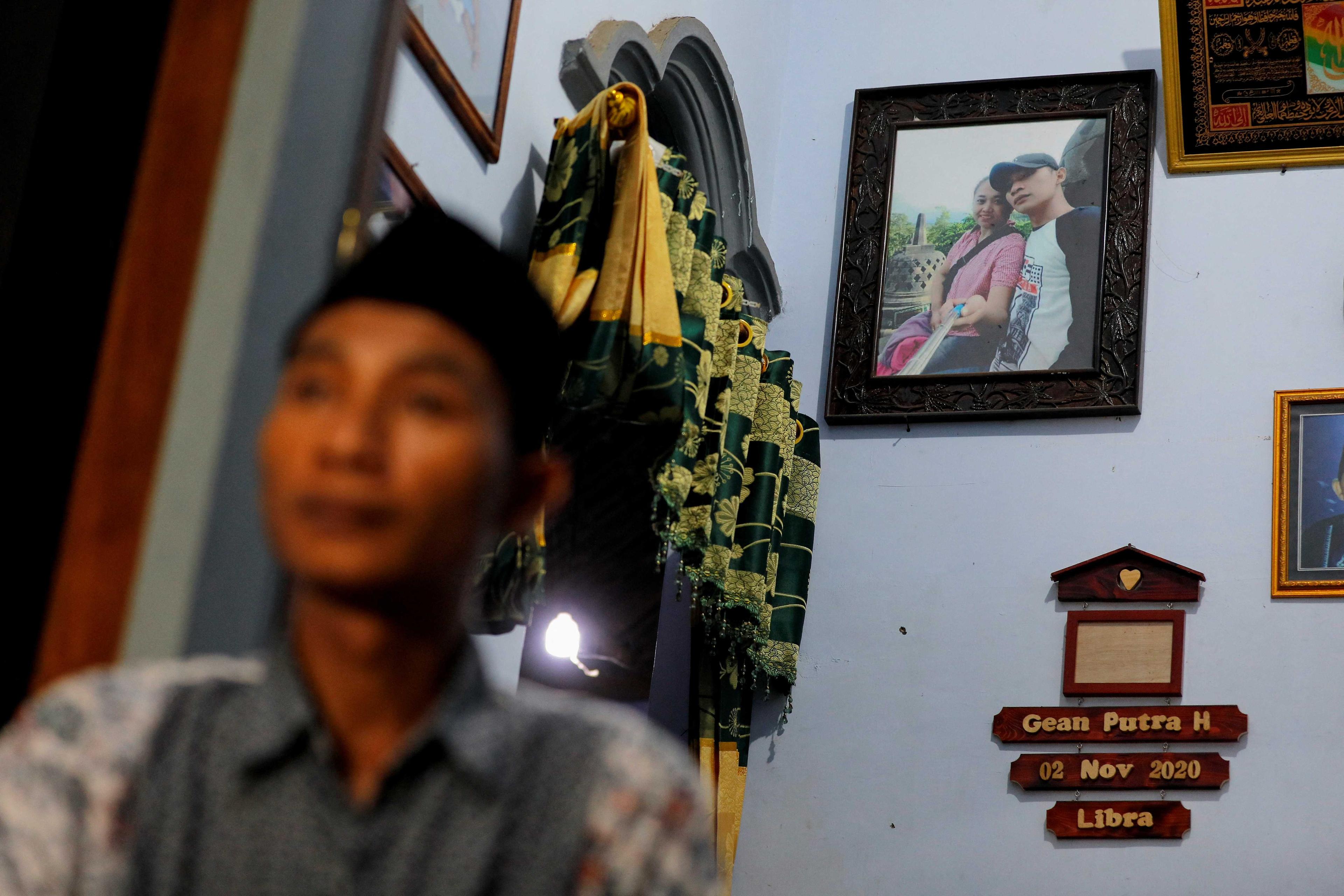 A picture of Andi Hariyanto and his late wife Gebi Asta Putri Purwoko, who died in a recent riot and stampede following a football match between Arema FC and Persebaya Surabaya at Kanjuruhan stadium, hangs on a wall at his house in Malang, East Java province, Indonesia, Oct 4. Photo: Reuters
