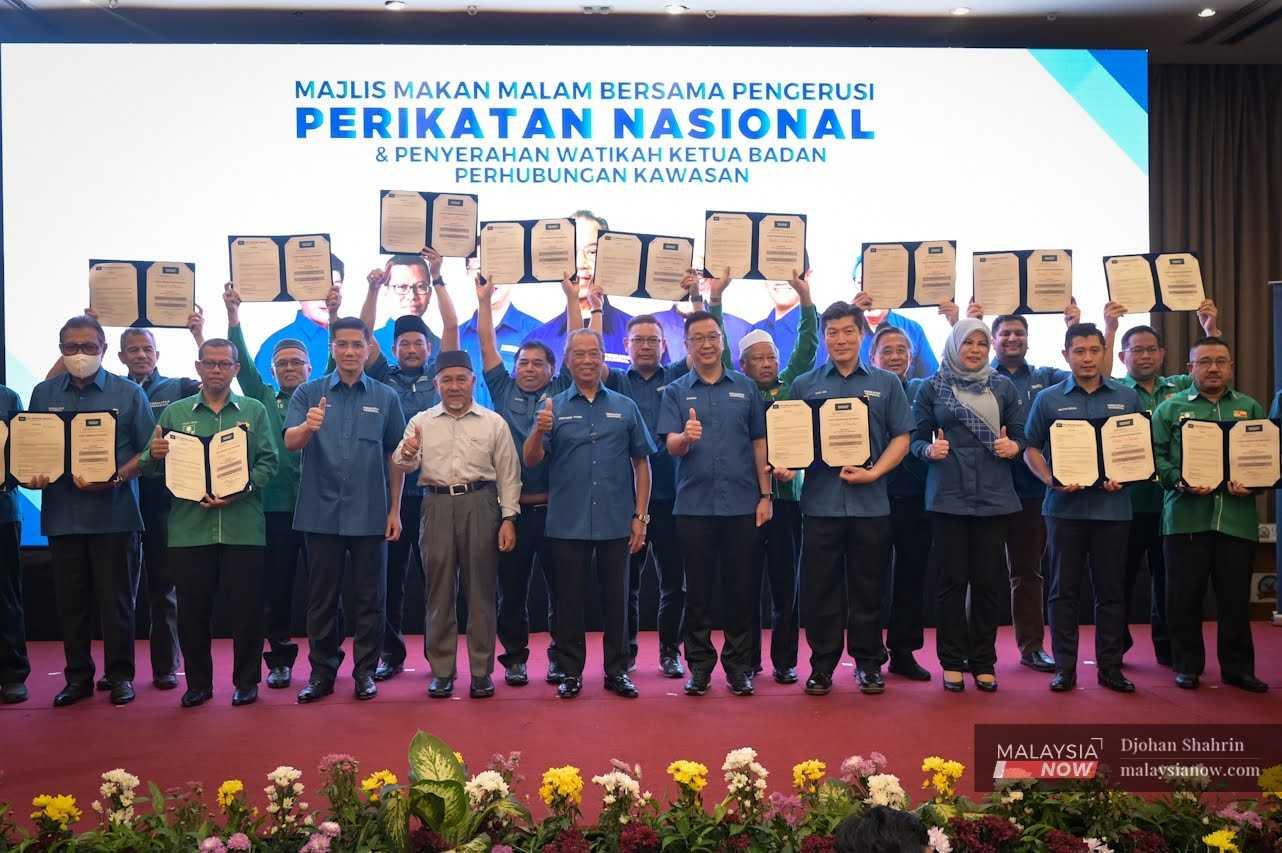 Perikatan Nasional chairman Muhyiddin Yassin with other coalition leaders after the distribution of responsibilities for work in Selangor at an event in Shah Alam last night.