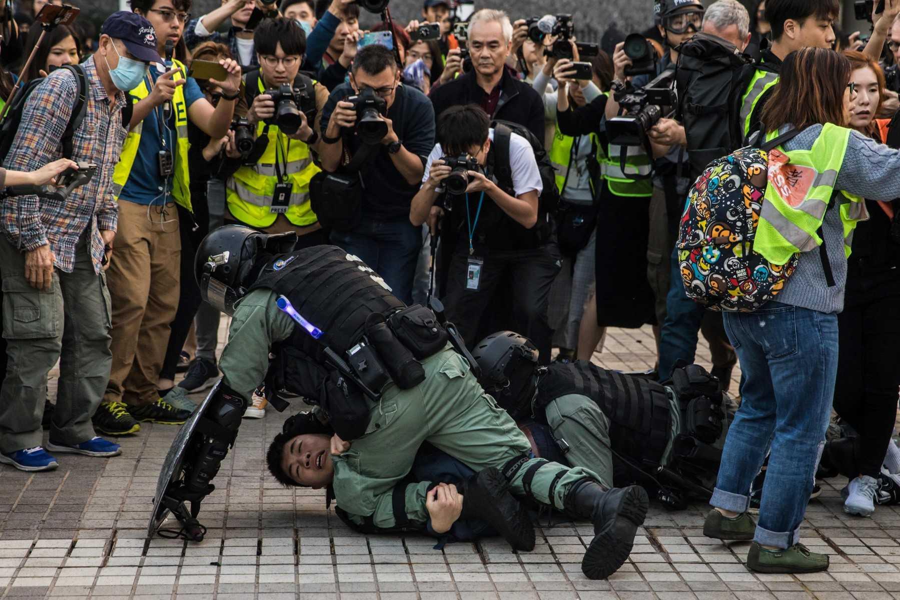 Police detain a man during a rally in Hong Kong on Dec 22, 2019 to show support for the Uighur minority in China. Photo: AFP 