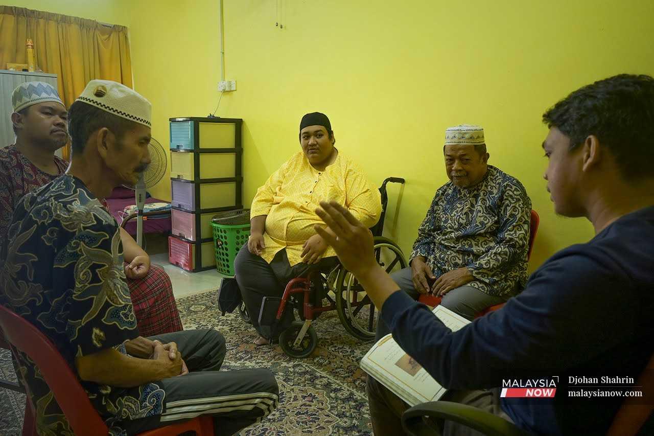 Ahmad Zahrin Anas sits with the other residents of Rumah Qaseh Ayah, an old folks' home in Sungai Petani, Kedah. 
