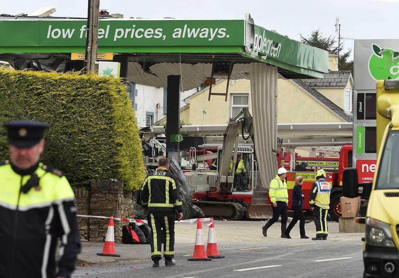Emergency services attend the scene of a explosion, resulting in multiple deaths, at a service station in the village of Creeslough, in County Donegal, Ireland, Oct 8. Photo: Reuters