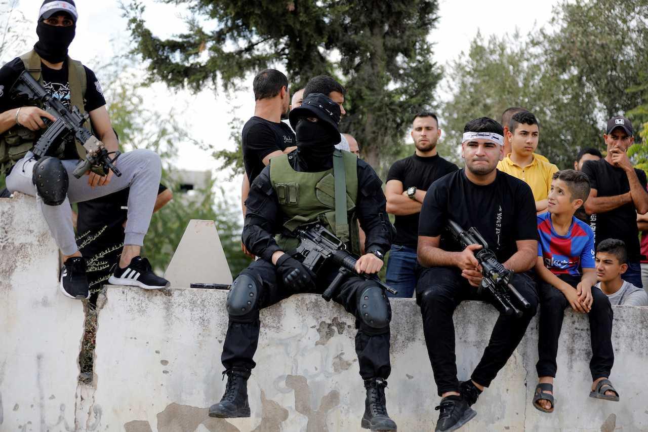 Armed men attend the funeral of a Palestinian who was killed by Israeli forces during clashes in raid, in Jenin in the Israeli-occupied West Bank, Oct 8. Photo: Reuters 