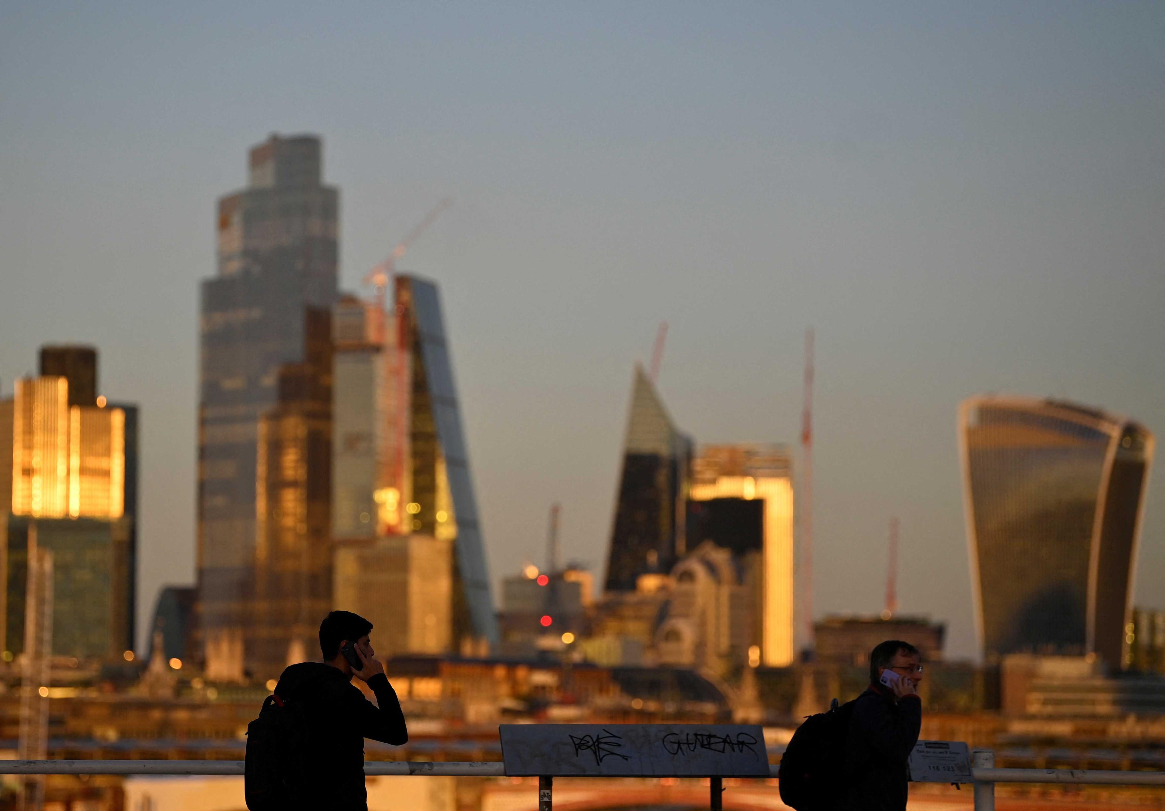 People cross Waterloo Bridge during the evening rush-hour with skyscrapers of the City of London financial district seen behind in London, Britain, Oct 10. Photo: Reuters