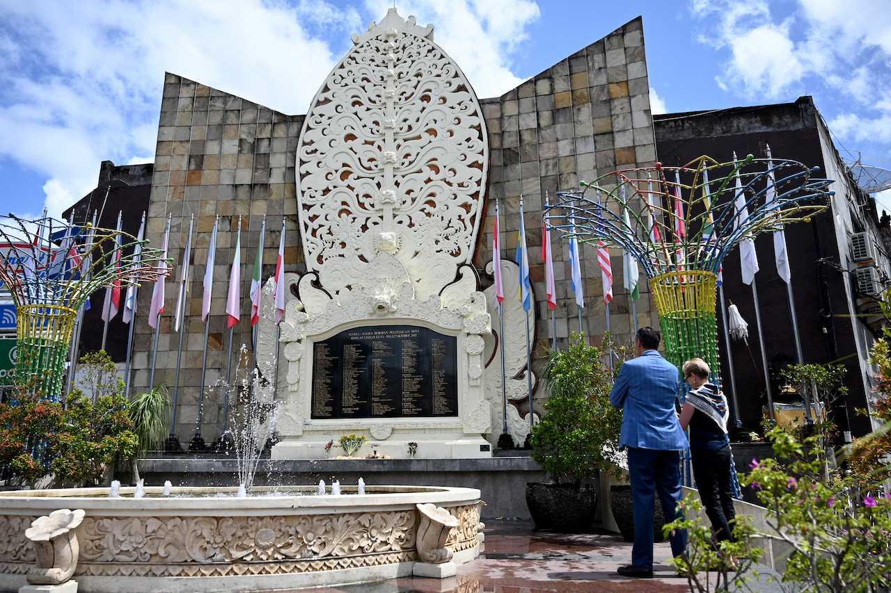 Foreign tourists visit the memorial for victims of the 2002 Bali bombings ahead of the 20th anniversary of the blasts, in the Kuta tourist area near Denpasar on the Indonesian resort island of Bali on Oct 8. Photo: AFP