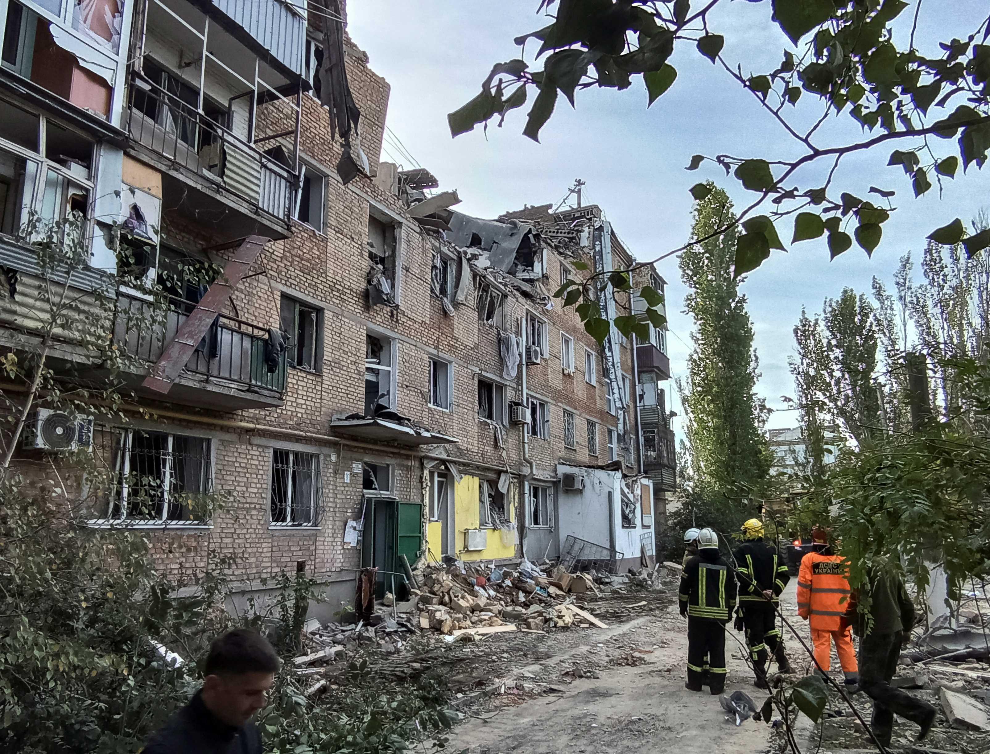 Rescuers work at the site of an apartment building damaged by a Russian military strike, as Russia's attack on Ukraine continues in Mykolaiv Oct 13.  Photo: Reuters