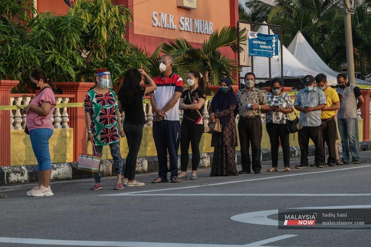 Voters queue to cast their ballots at the SMK Sri Muar polling centre for the Johor election in March. 