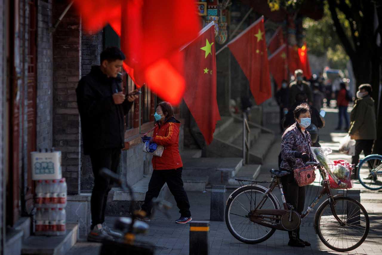 A view of Chinese national flags in a street of an old neighbourhood as the city prepares for the 20th National Congress of the Communist Party of China, in Beijing, China, Oct 11. Photo: Reuters