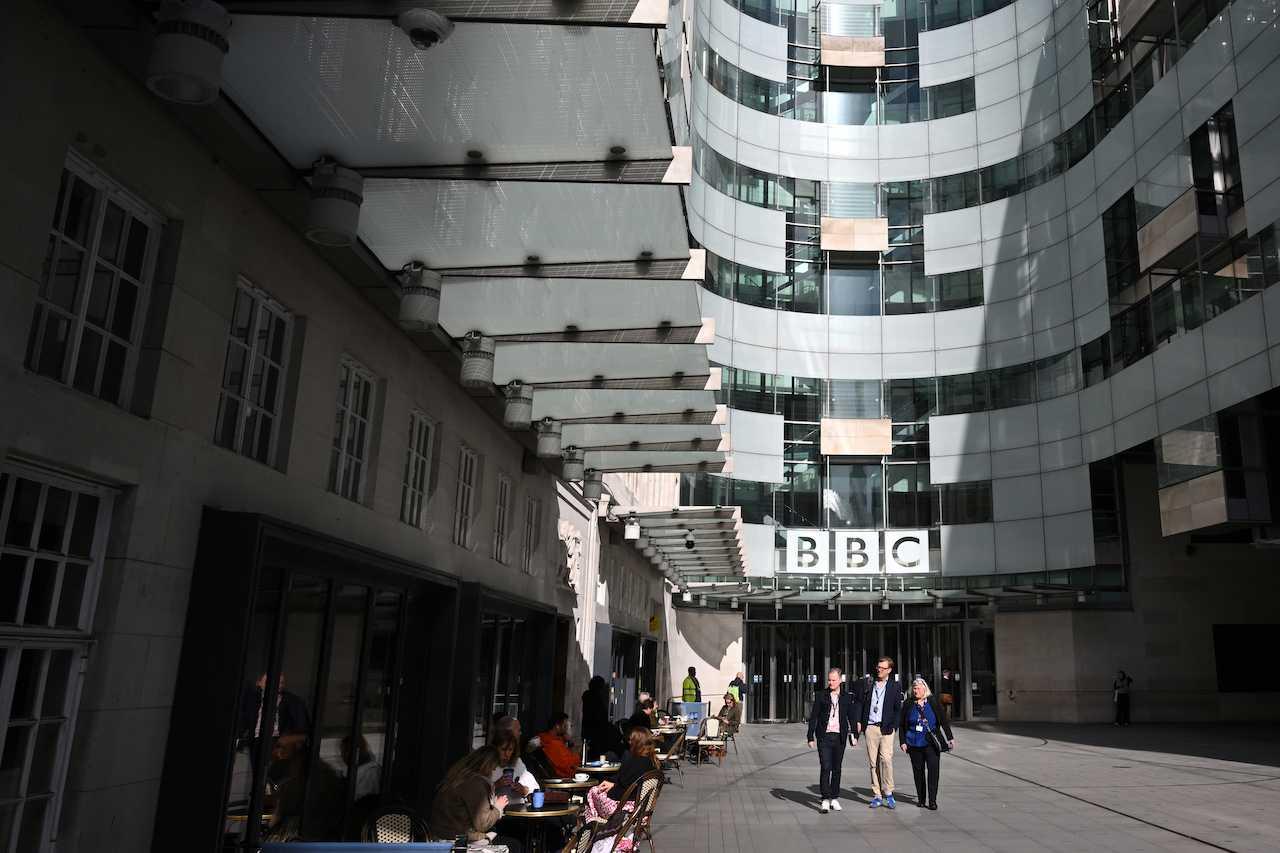 Pedestrians walk past the BBC headquarters at the Broadcasting House in central London on Oct 6. Photo: AFP