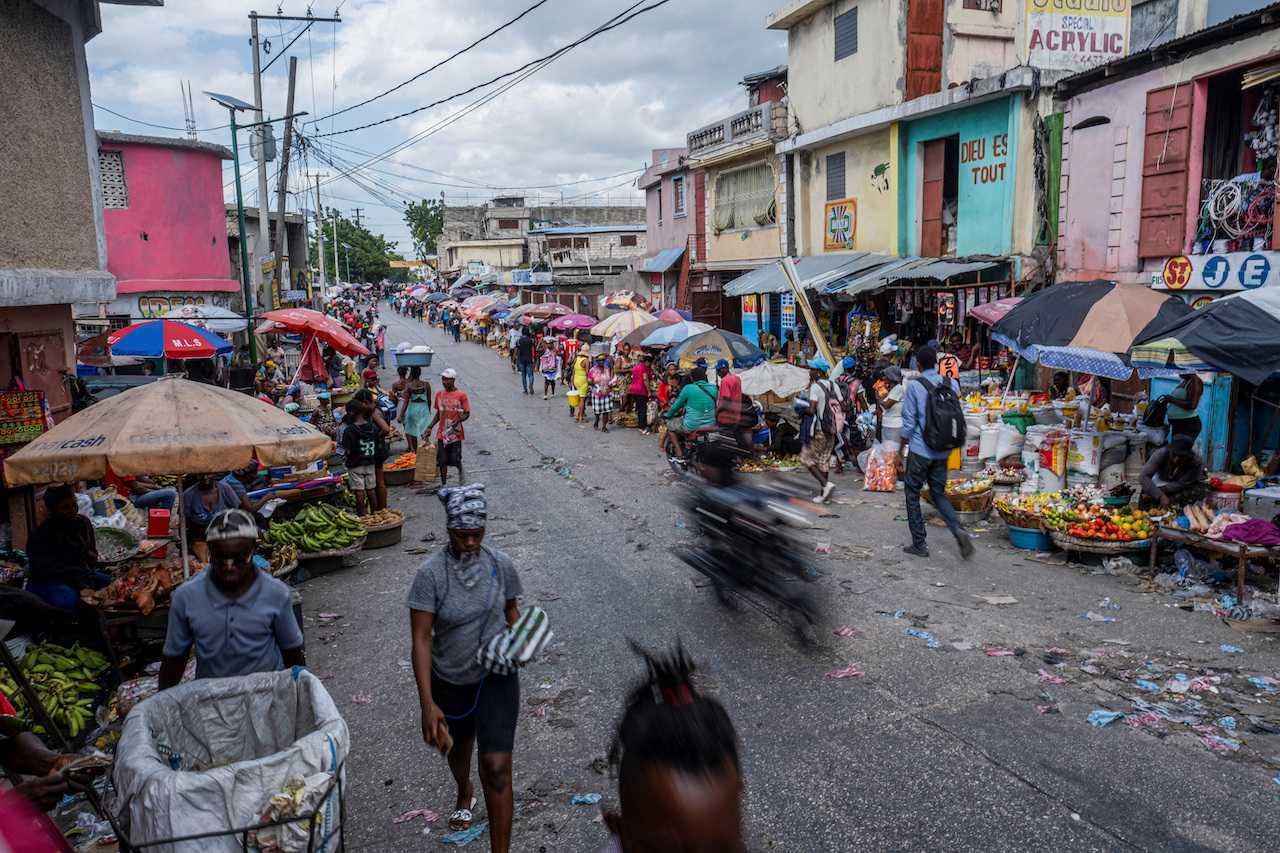 People walk on a quiet market street usually packed with people and heavy traffic in Port-au-Prince, Haiti, Oct 13. Photo: Reuters
