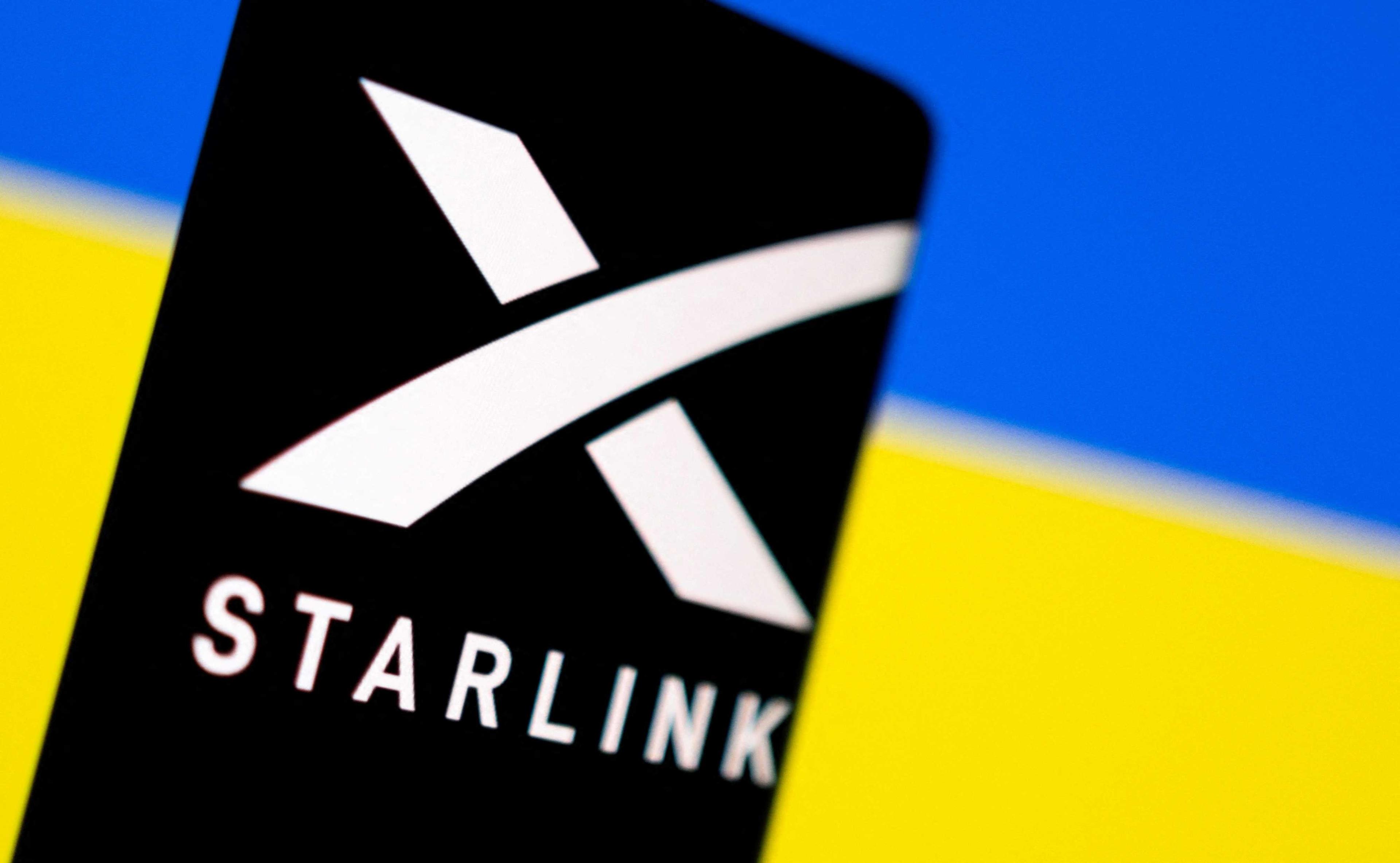 Starlink logo is seen on a smartphone in front of displayed Ukrainian flag in this illustration taken Feb 27. Photo: Reuters