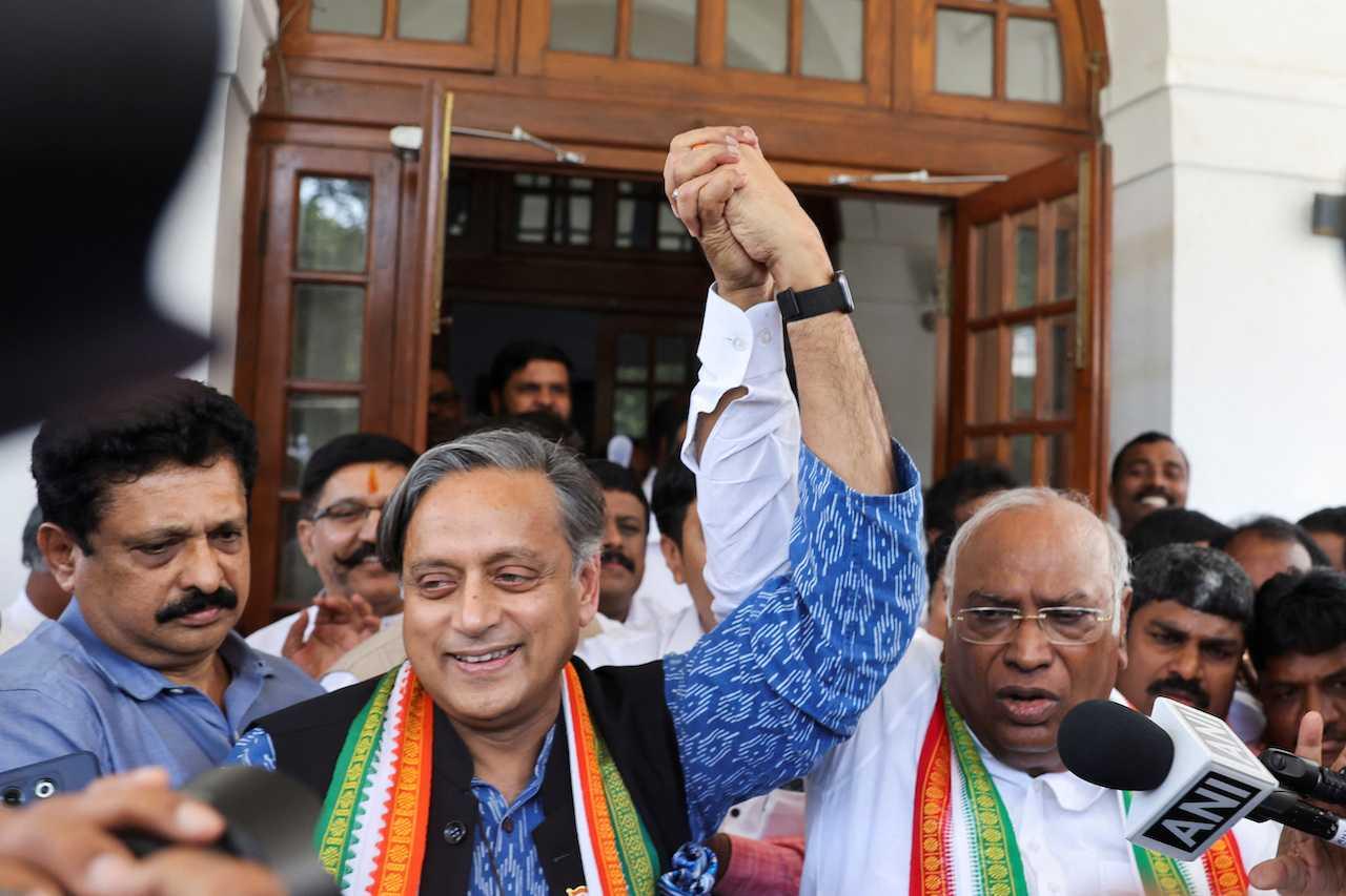 Mallikarjun Kharge, newly elected president of the Congress party, India's main opposition party, raises his hand with party colleague Shashi Tharoor at Kharge’s residence in New Delhi, India, Oct 19. Photo: Reuters