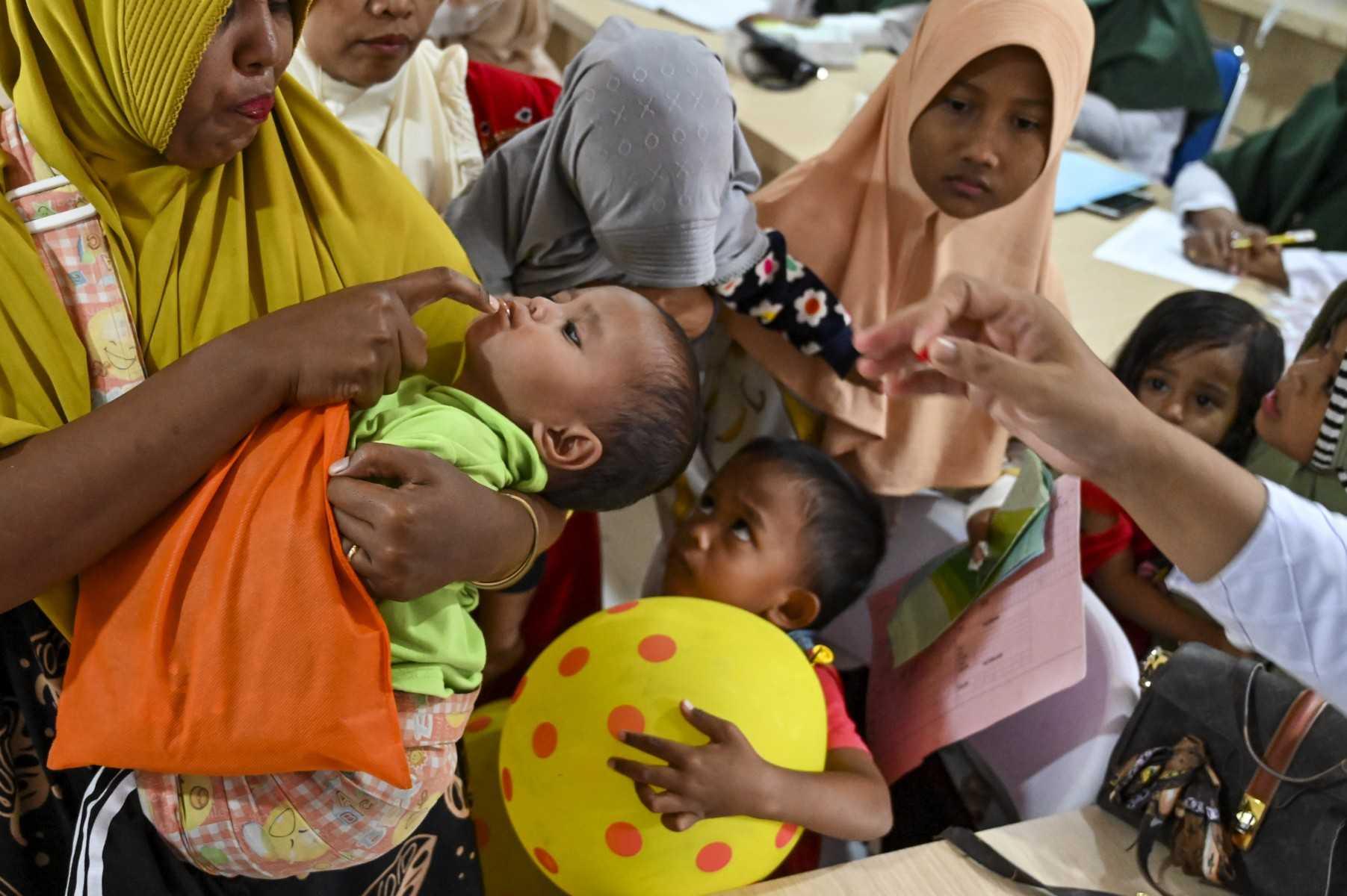 A baby receives a supplement during a routine medical check up for a children program at an integrated services post in Banda Aceh on Aug 2. Photo: AFP 