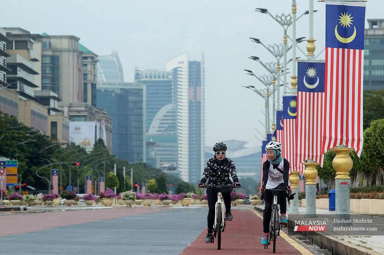 Two women ride their bicycles through Presint 2 in Putrajaya, the administrative capital of the country, in this file picture. 