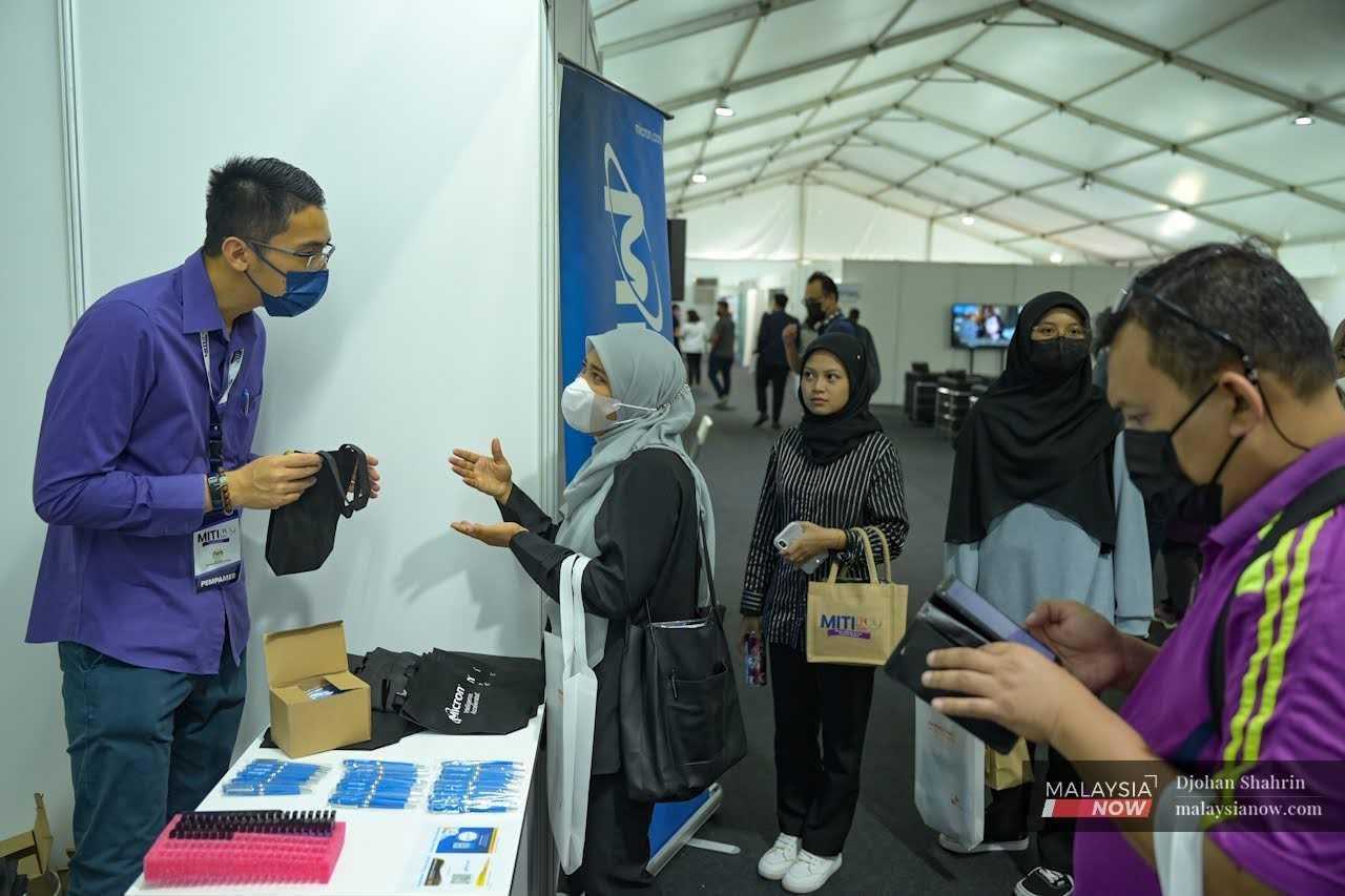 Jobseekers enquire at one of the booths at a recent job fair in Taman Melawati, Selangor. 
