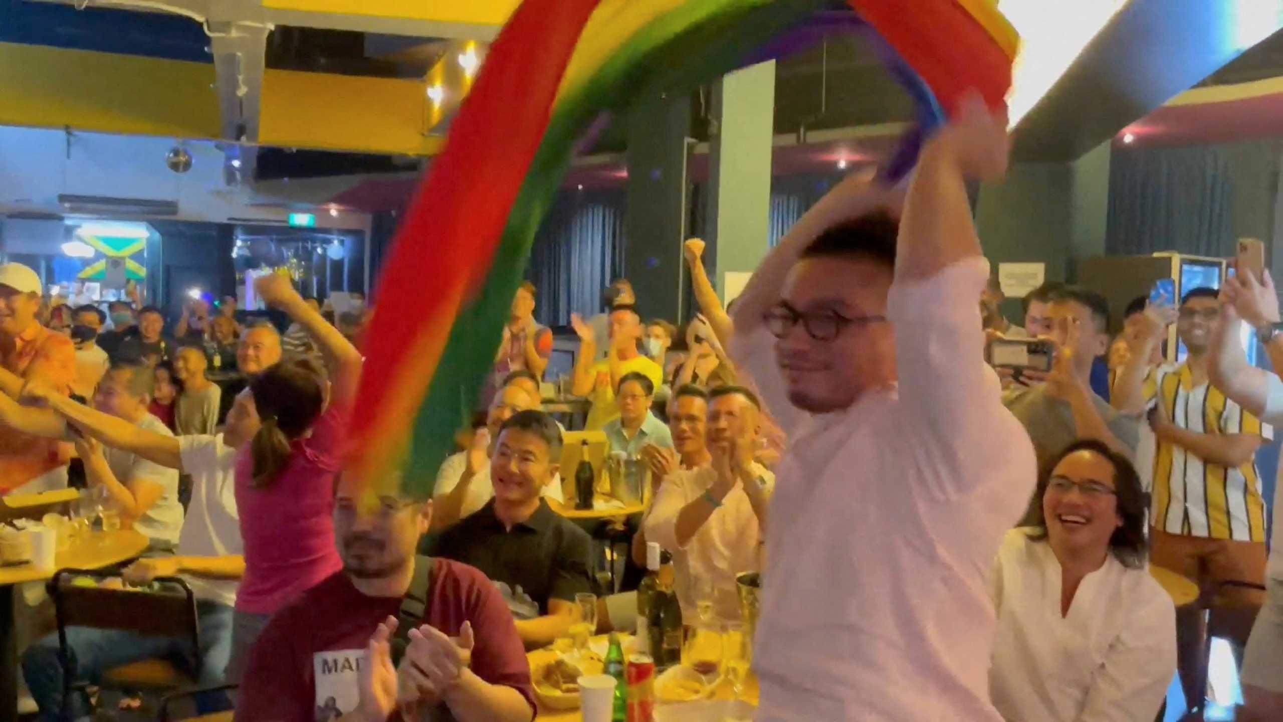 A man waves a rainbow flag after Singapore's Prime Minister Lee Hsien Loong announces that Singapore will decriminalise gay sex, in Singapore, Aug 21, this screen grab obtained from a social media video. Photo: Reuters