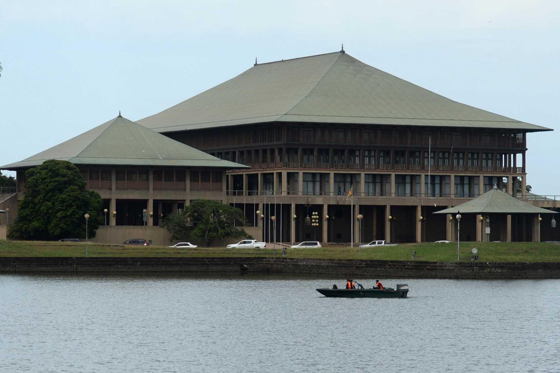 Army cadets patrol in a boat in front of Sri Lankan parliament building in Colombo on July 16. Photo: AFP
