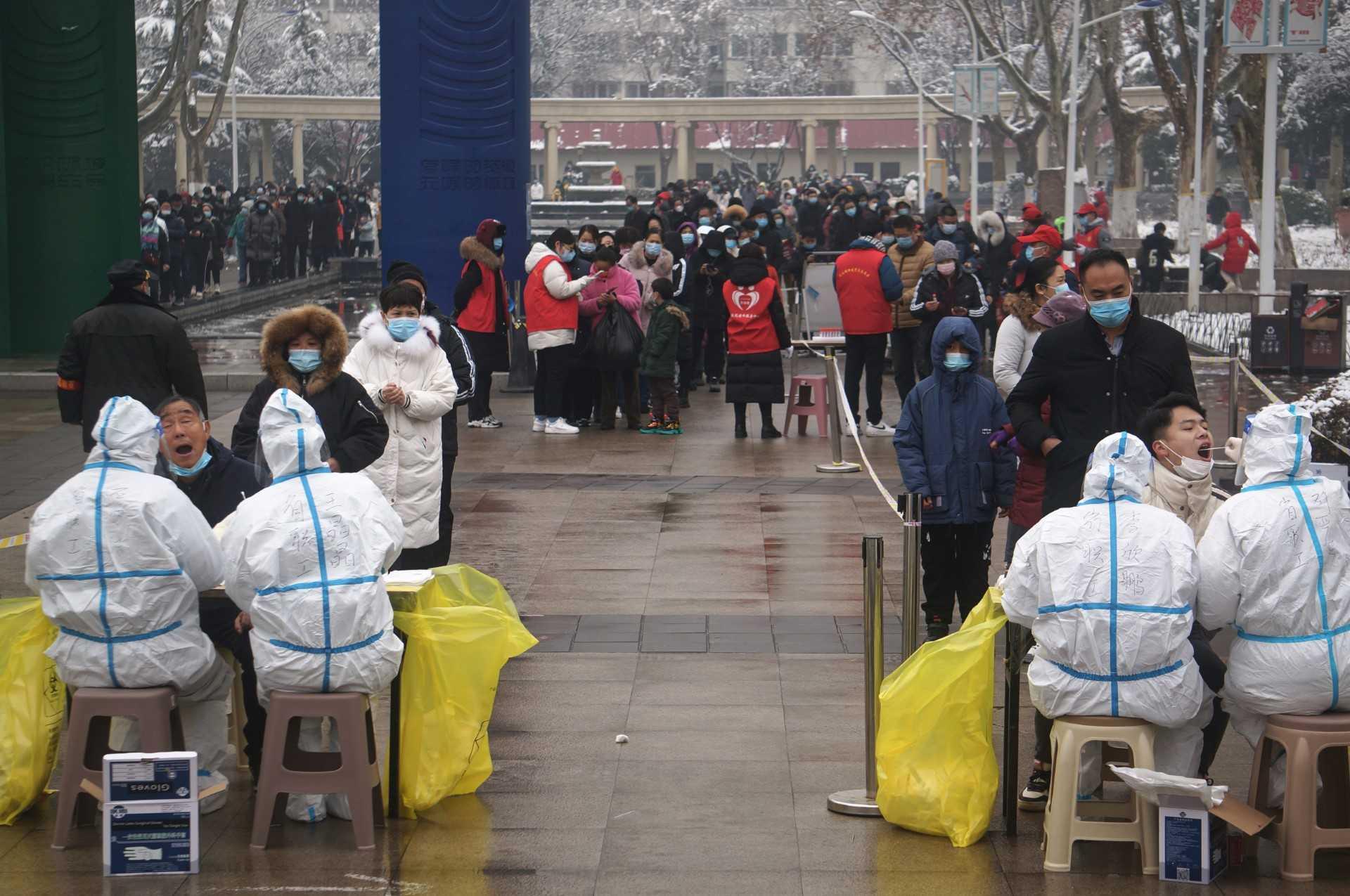 Residents queue to receive Covid-19 tests as part of a mass testing programme in Zhengzhou, in China's central Henan province in this file photo taken on Jan 5. Photo: AFP