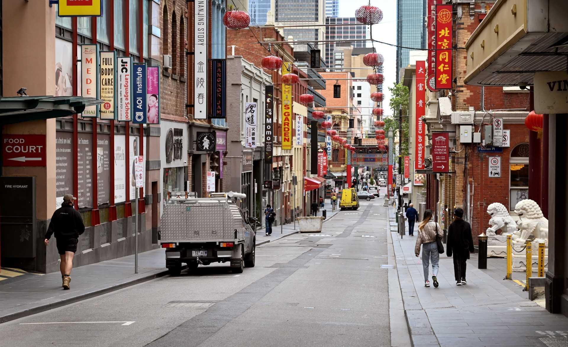 People walk down a street in Melbourne's Chinatown on Oct 19, 2021. Photo: AFP