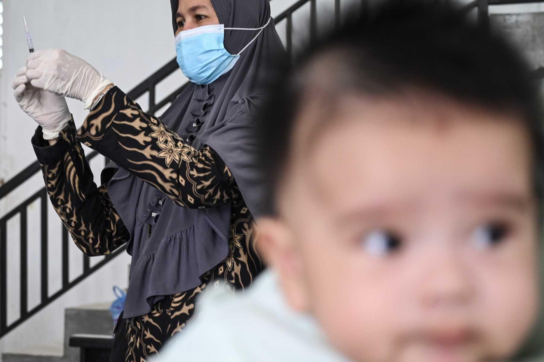A nurse prepares a Bacillus Calmette-Guerin vaccine for tuberculosis during a national immunisation for children programme at an integrated services post in Banda Aceh on June 9. Photo: AFP