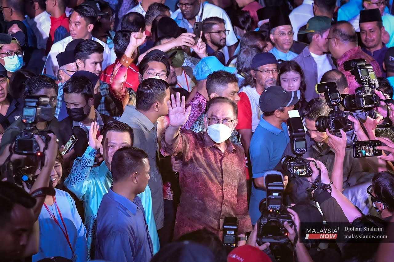 PKR president Anwar Ibrahim waves after the announcement of the party's candidates for the 15th general election in Ampang, Selangor, on Oct 28.