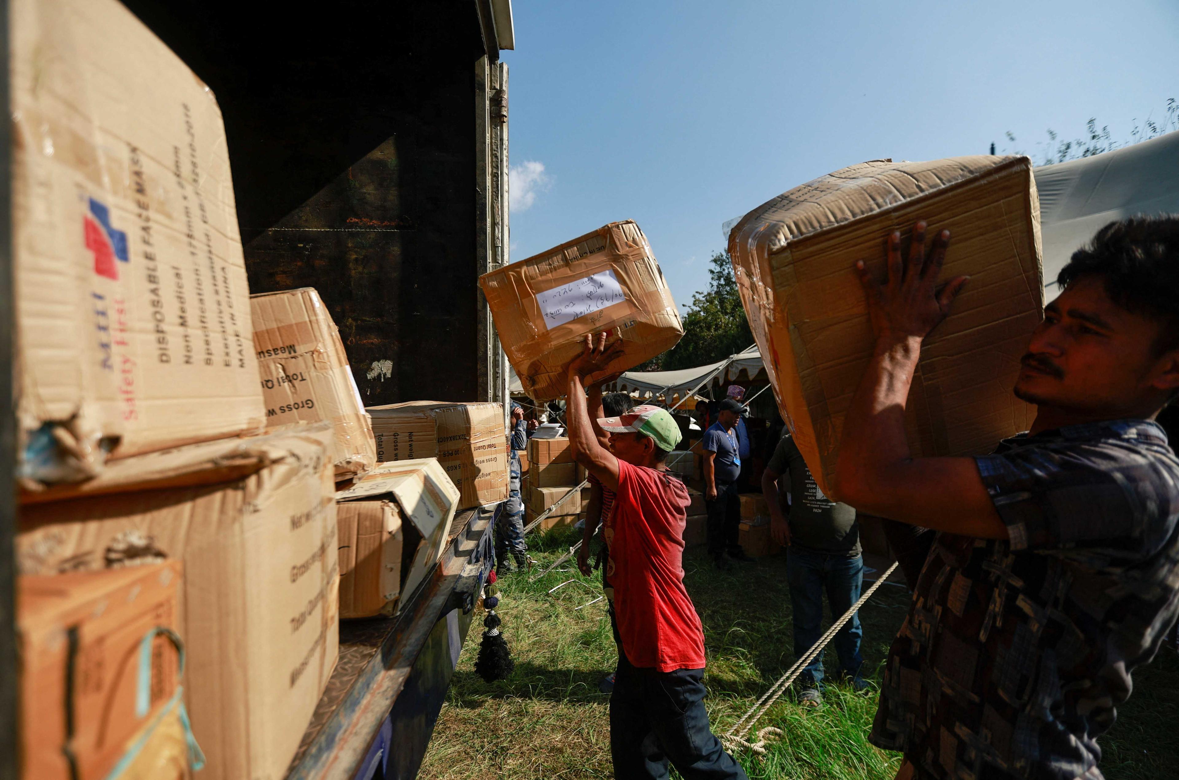 Men load boxes containing materials for the upcoming general election into a truck at the Election Commission in Kathmandu, Nepal Oct 31. Photo: Reuters