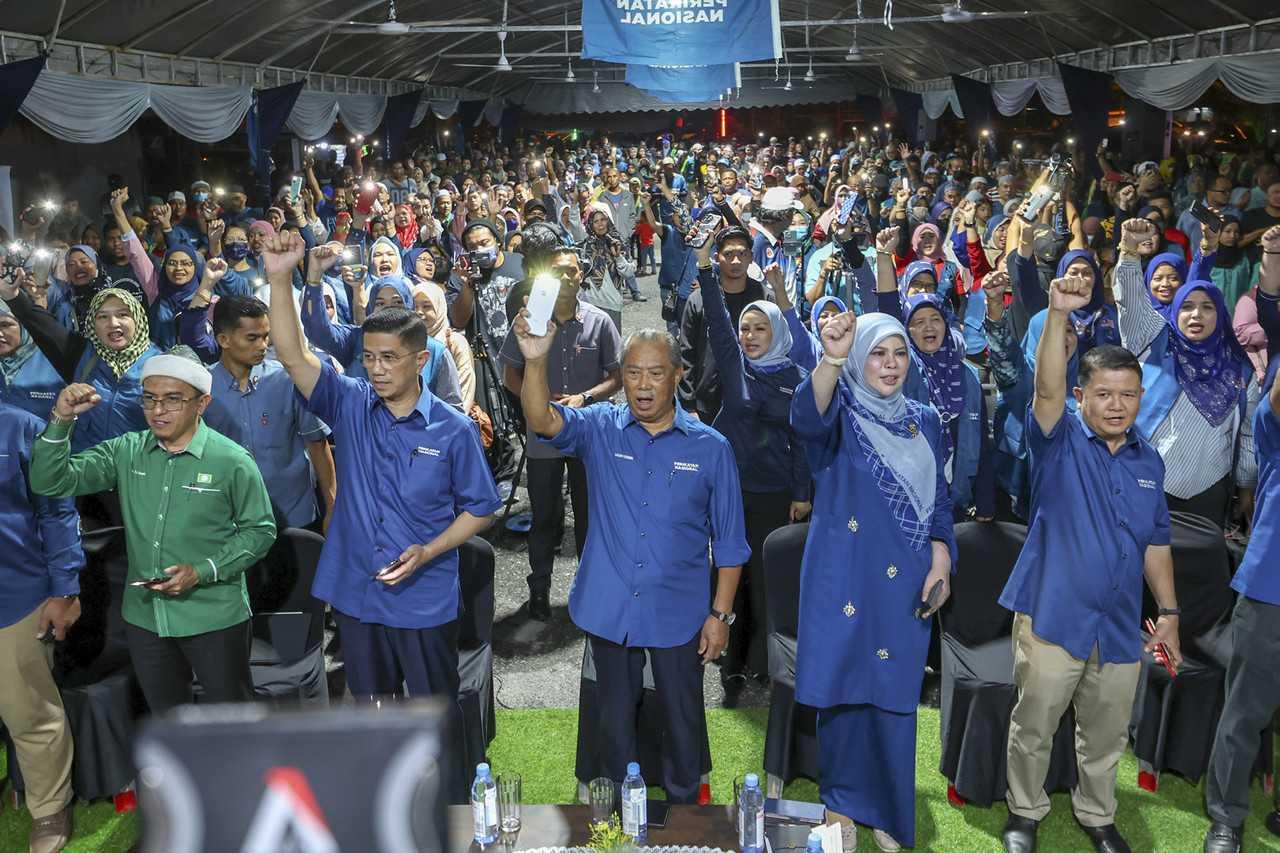 Perikatan Nasional chairman Muhyiddin Yassin with information chief Mohamed Azmin Ali and the coalition's candidate for Sepang, Rina Harun, at an event in Dengkil last night. Photo: Bernama