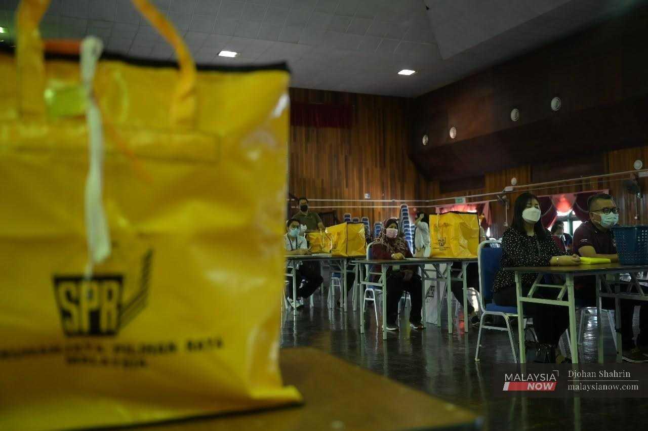 Election Commission workers are briefed about their duties ahead of early voting for the Sarawak election in December last year.