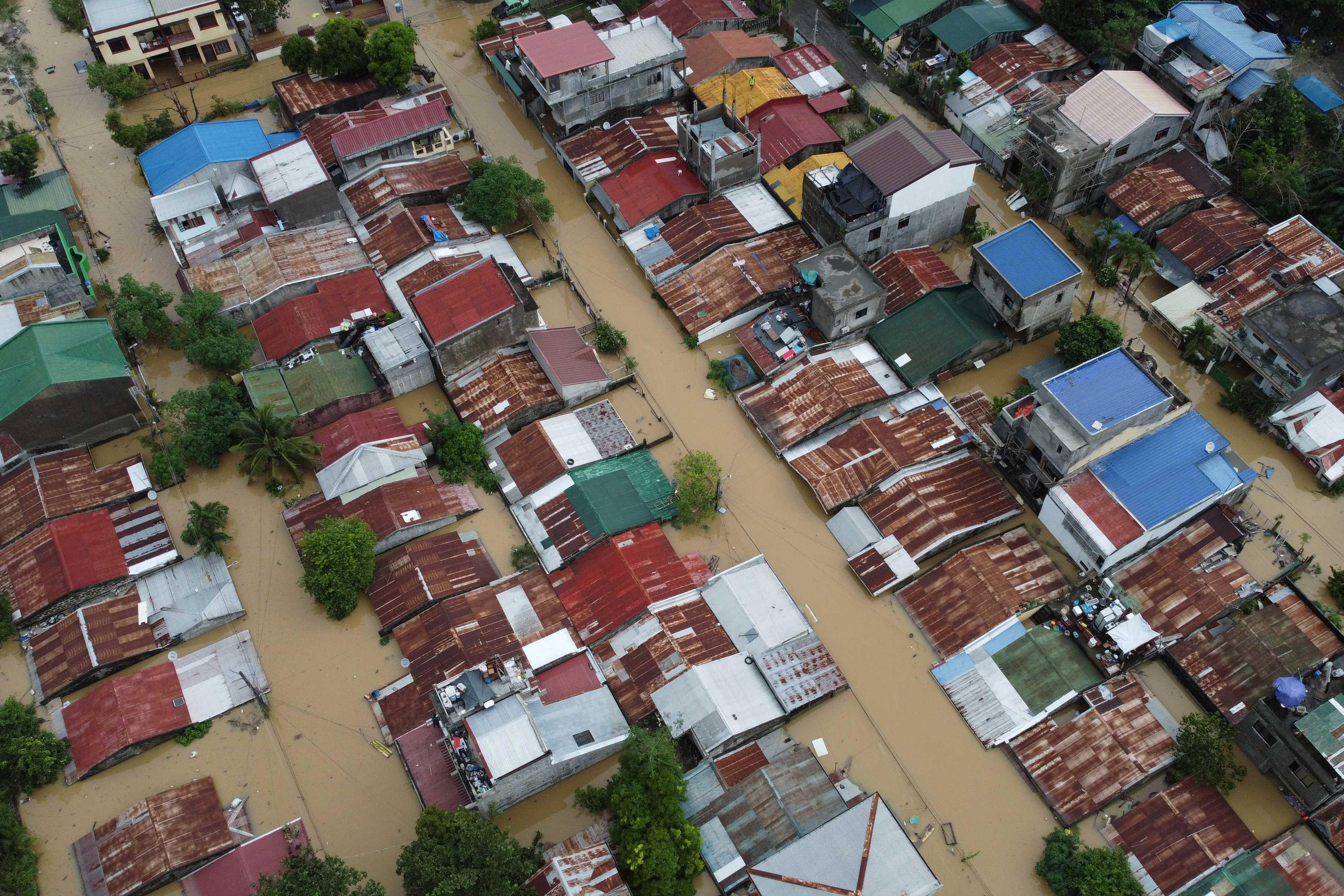 An aerial view shows flood-inundated houses at Capitol Hills in Alibagu, Ilagan city, Isabela province on Oct 31, after Tropical Storm Nalgae hit the region. Photo: AFP 