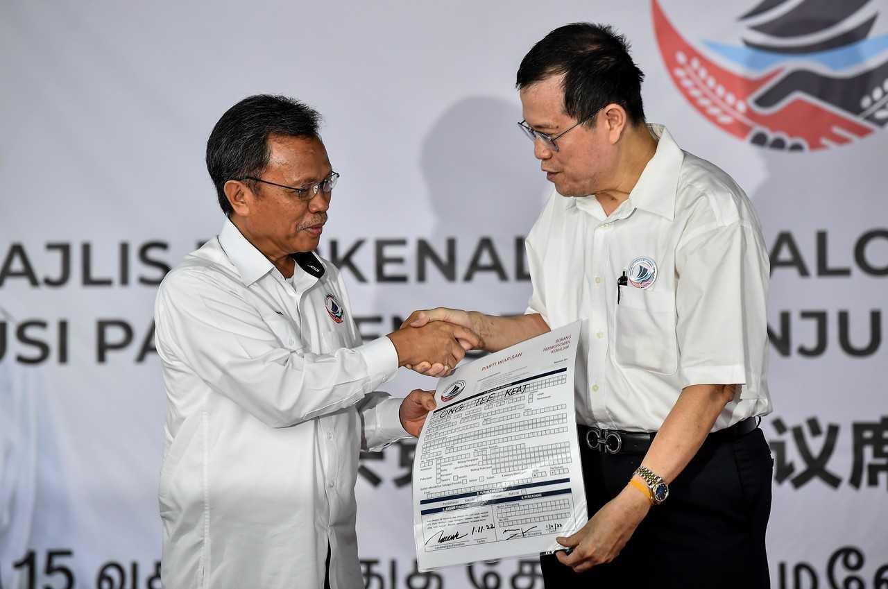 Presiden Warisan Shafie APdal menyerahkan penerimaan permohonan keahlian bekas presiden MCA Ong Tee Keat di acara pengumuman calon Warisan di Kuala Lumpur pada 1 November. Gambar: Bernama