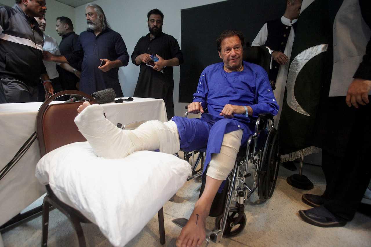 Former Pakistan prime minister Imran Khan sits in a wheelchair after he was wounded following a shooting incident on a long march in Wazirabad, in Lahore, Pakistan, Nov 4. Photo: Reuters