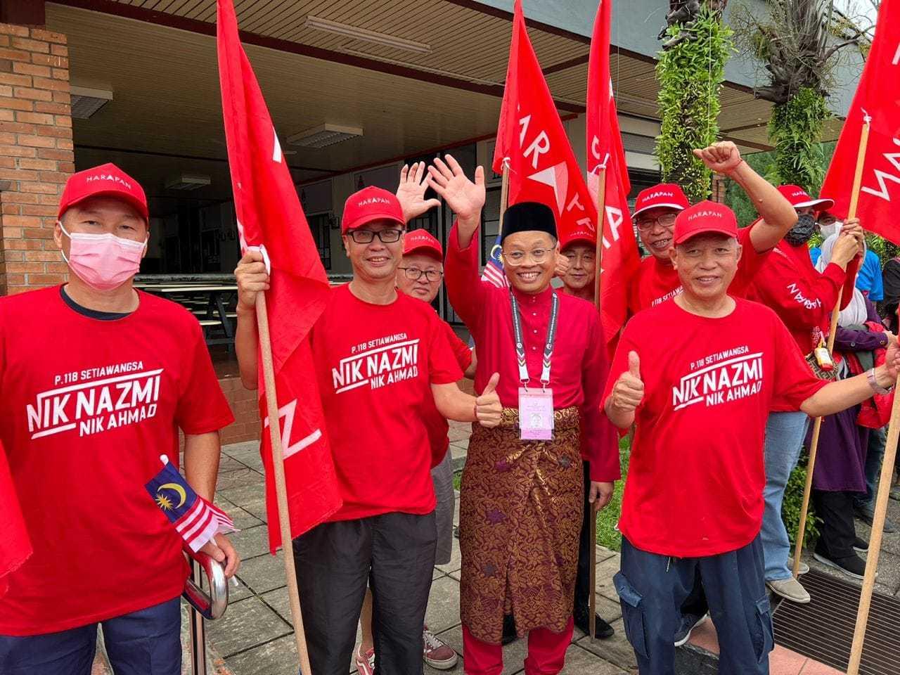 PKR's Nik Nazmi Nik Ahmad waves alongside supporters on nomination day for the 15th general election where he will be defending his Setiawangsa seat. Photo: Facebook 
