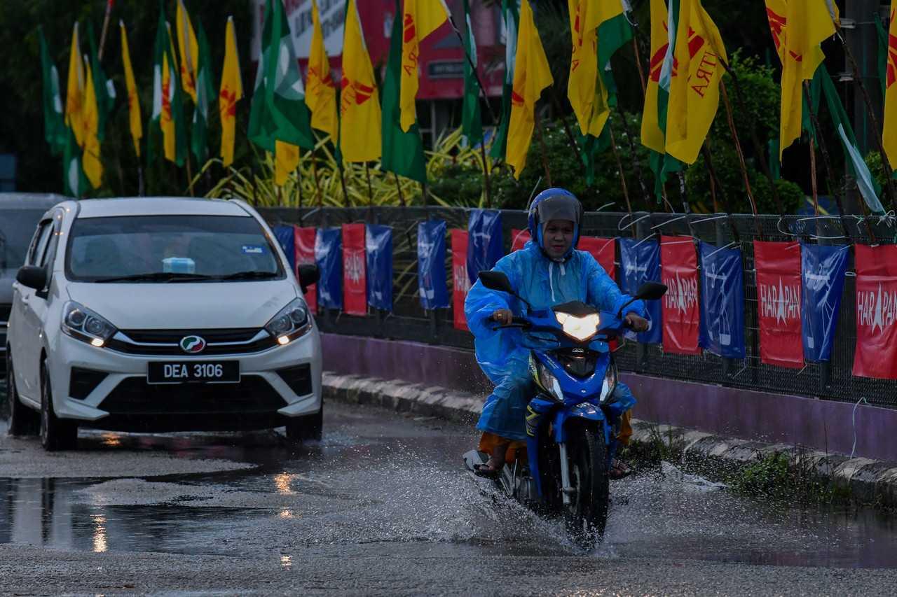 Seorang penunggang motorsikal meredah becak air di Pasir Mas, Kelantan. Gambar: Bernama