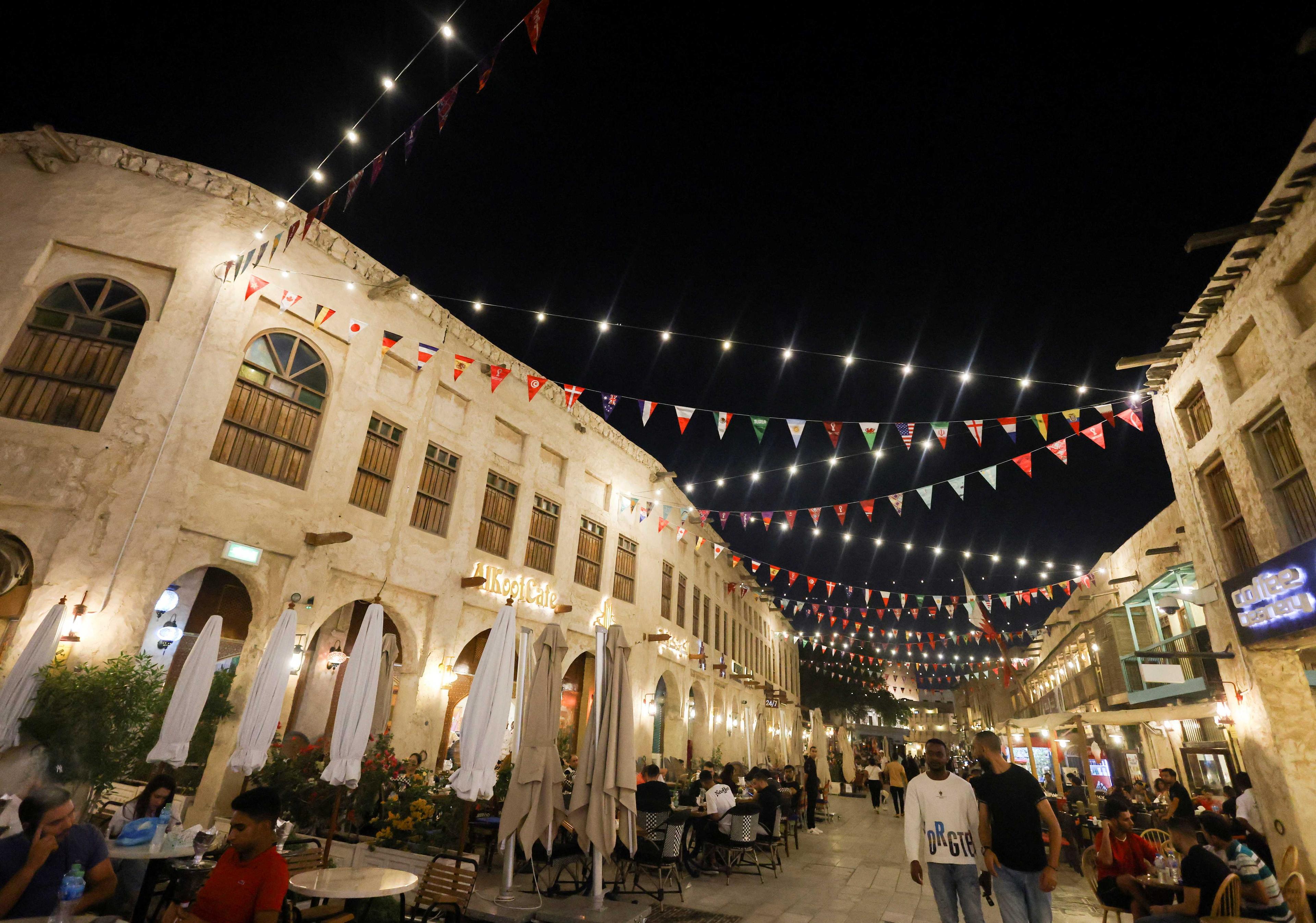 People walk at Souq Waqif, which has been decorated with international flags, ahead of the Fifa World Cup 2022 soccer tournament in Doha, Qatar Nov 7. Photo: Reuters