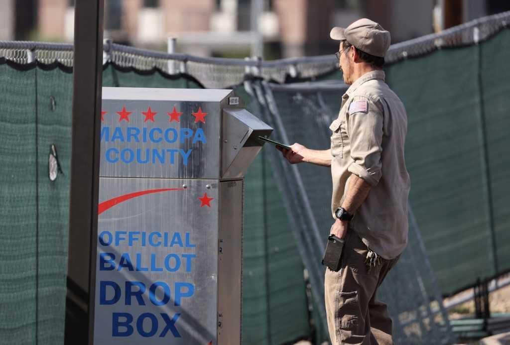 A voter drops his ballot into a drop box on Nov 7, in Phoenix, Arizona, the US. Photo: AFP