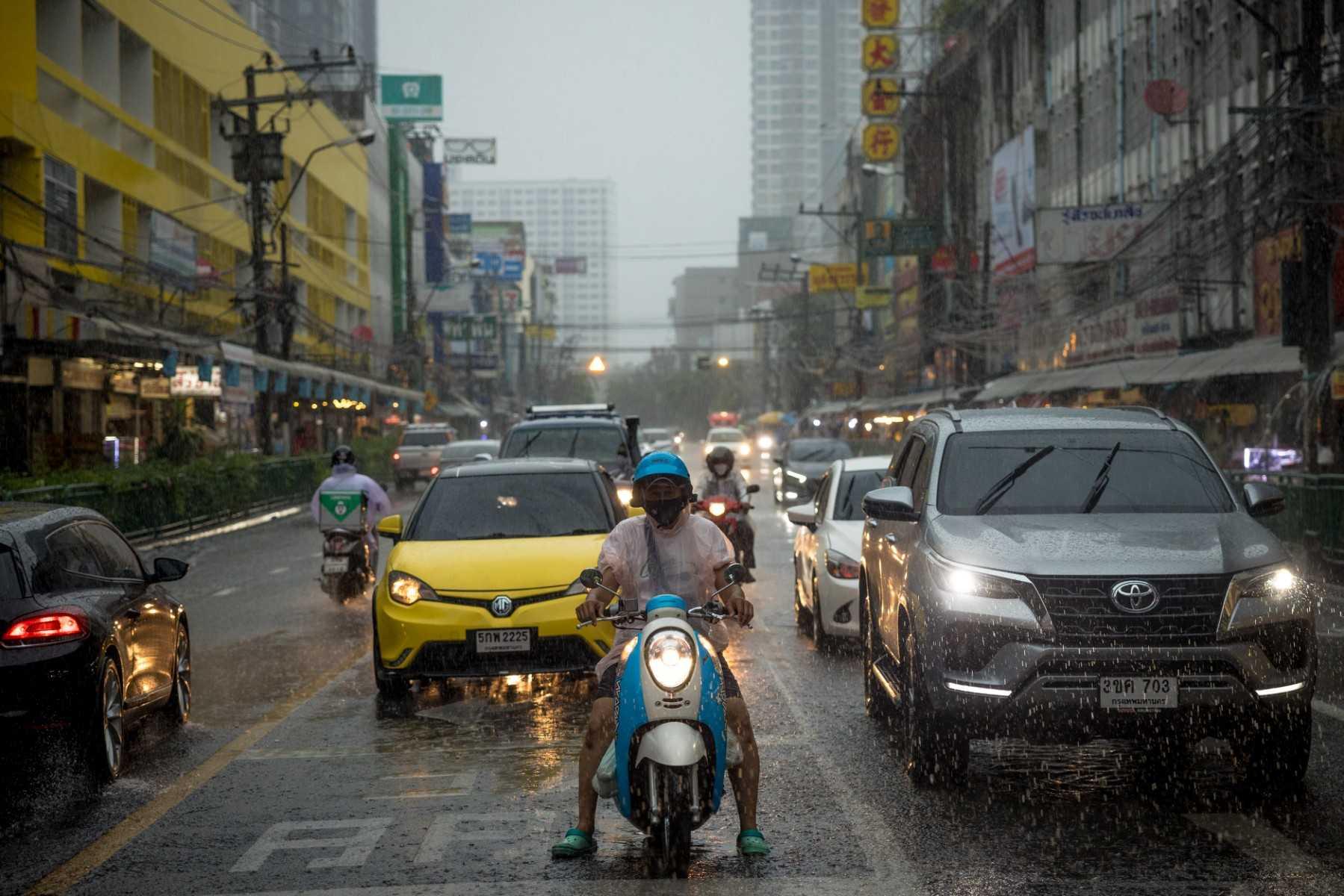 Motorists wait at a red light during heavy rain in Bangkok on Aug 1. Photo: AFP 