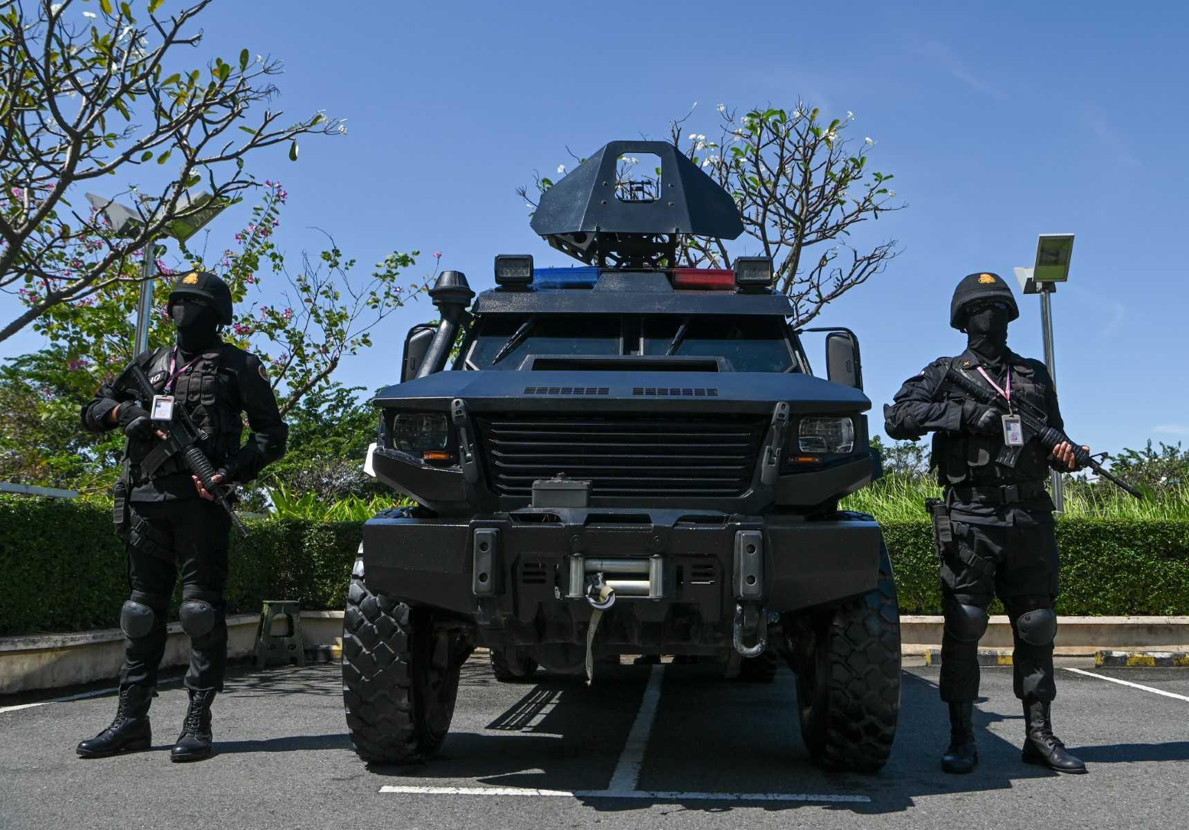 Members of the elite Cambodian prime minister's bodyguard unit stand guard near their vehicle as part of security measures for the upcoming Asean summit in Phnom Penh on Nov 7. Photo: AFP