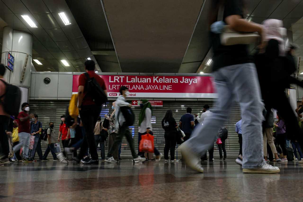 Commuters seen at the KL Sentral LRT station after technical problems on the line yesterday. Photo: Bernama