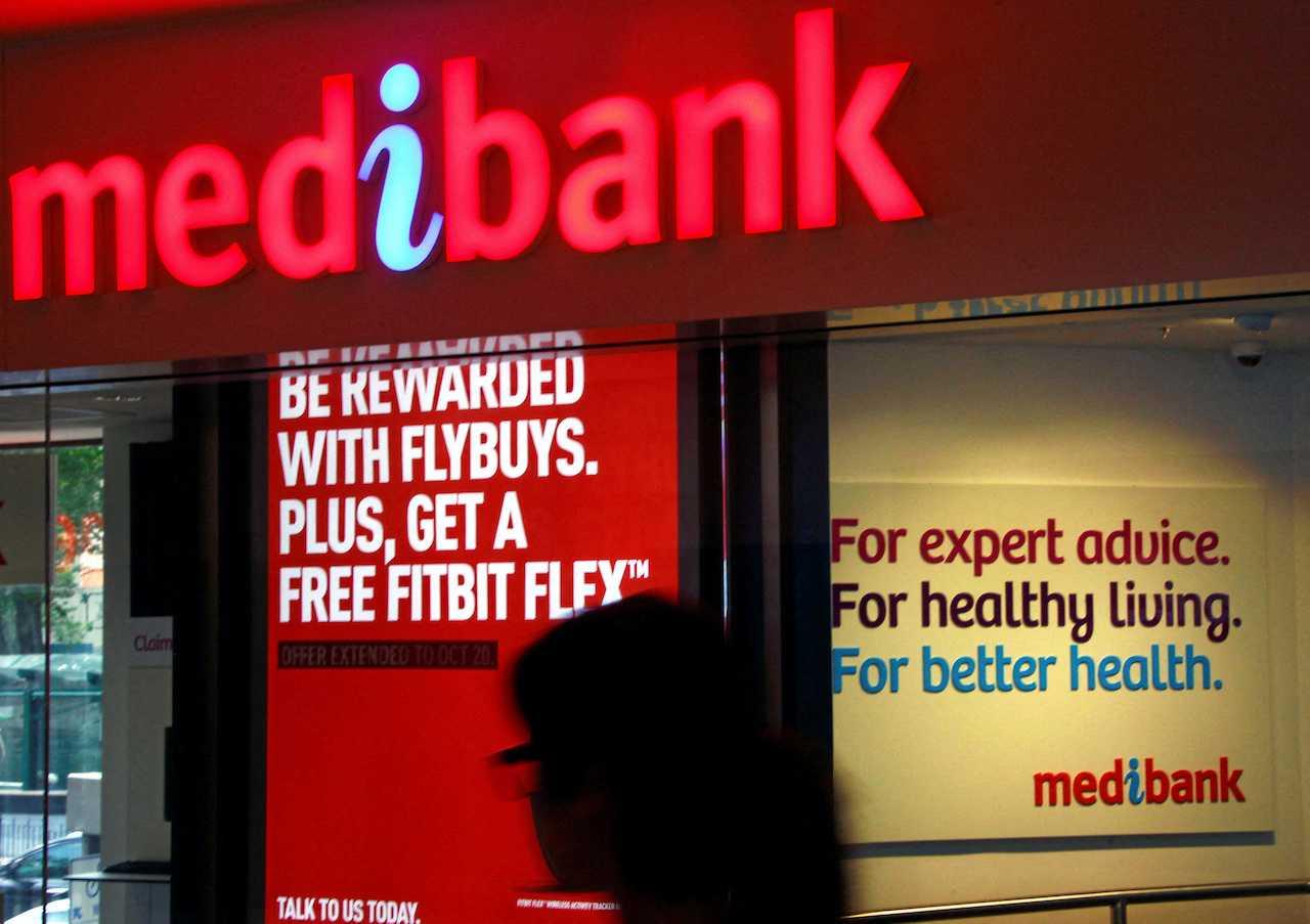 A woman walks past a branch of Australian health insurer Medibank Private in Sydney, Oct 20, 2014. Photo: Reuters