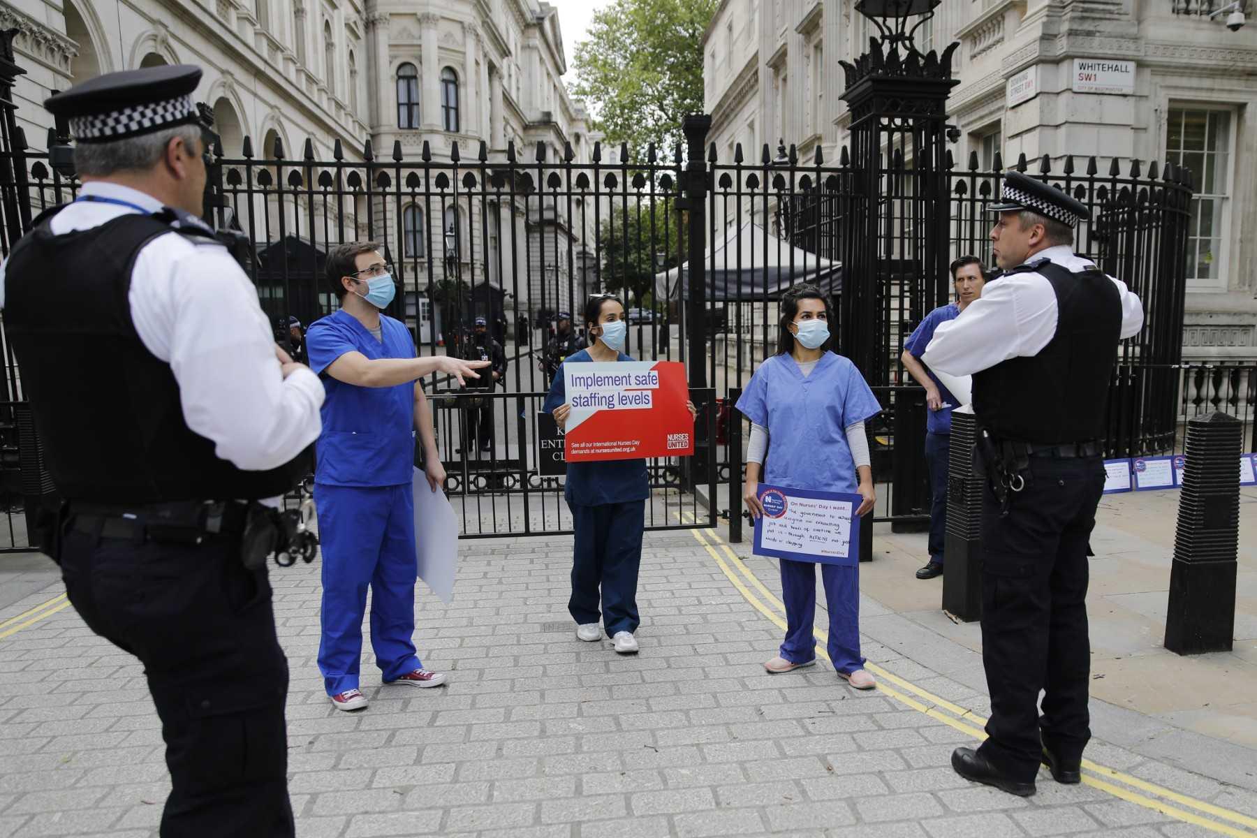 Nurses protest with placards outside Downing Street in central London on May 13, 2020. Photo: AFP