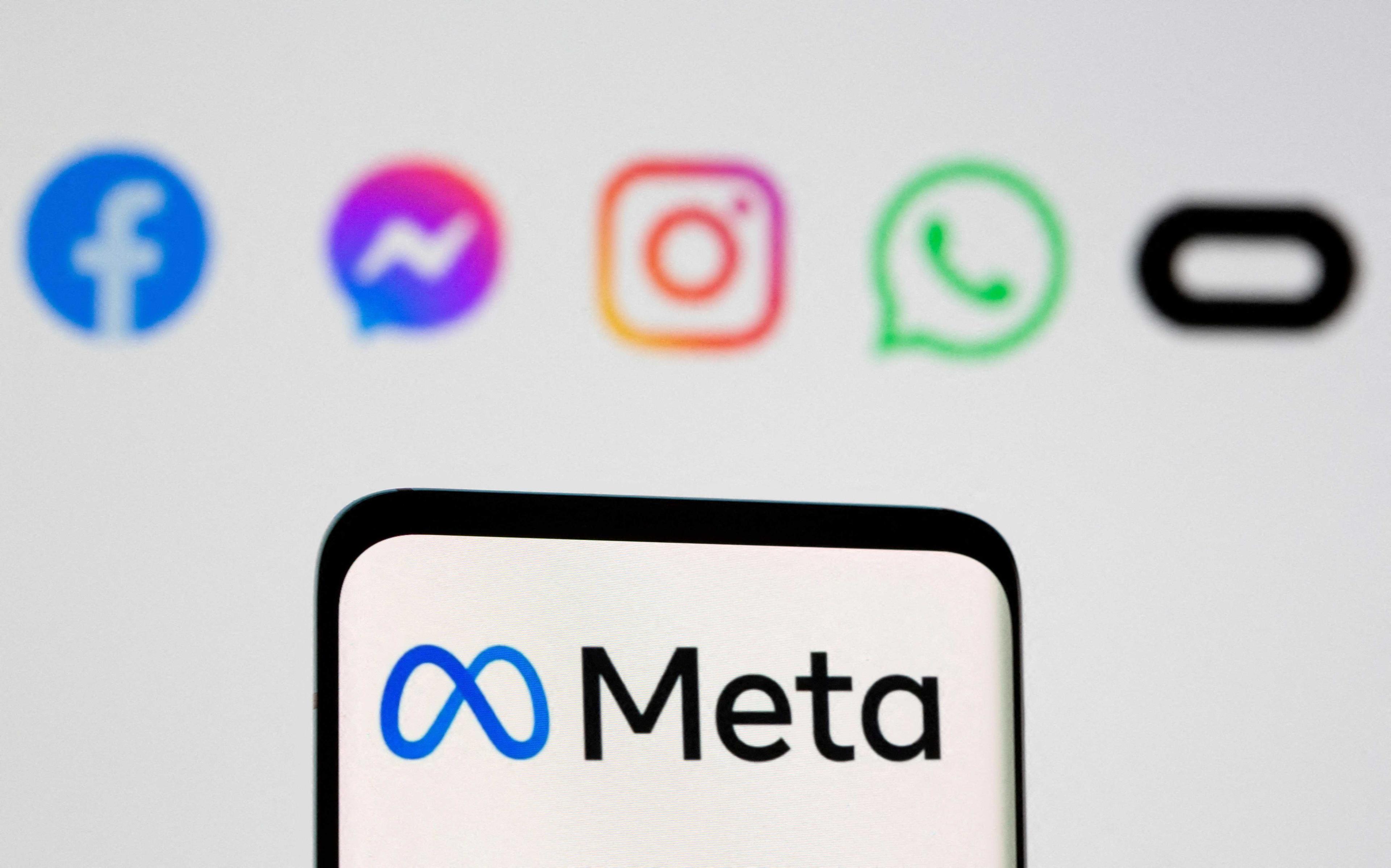 The Meta logo is seen on smartphone in front of displayed logos of Facebook, Messenger, Instagram, WhatsApp, Oculus in this illustration picture taken Oct 28, 2021. Photo: Reuters