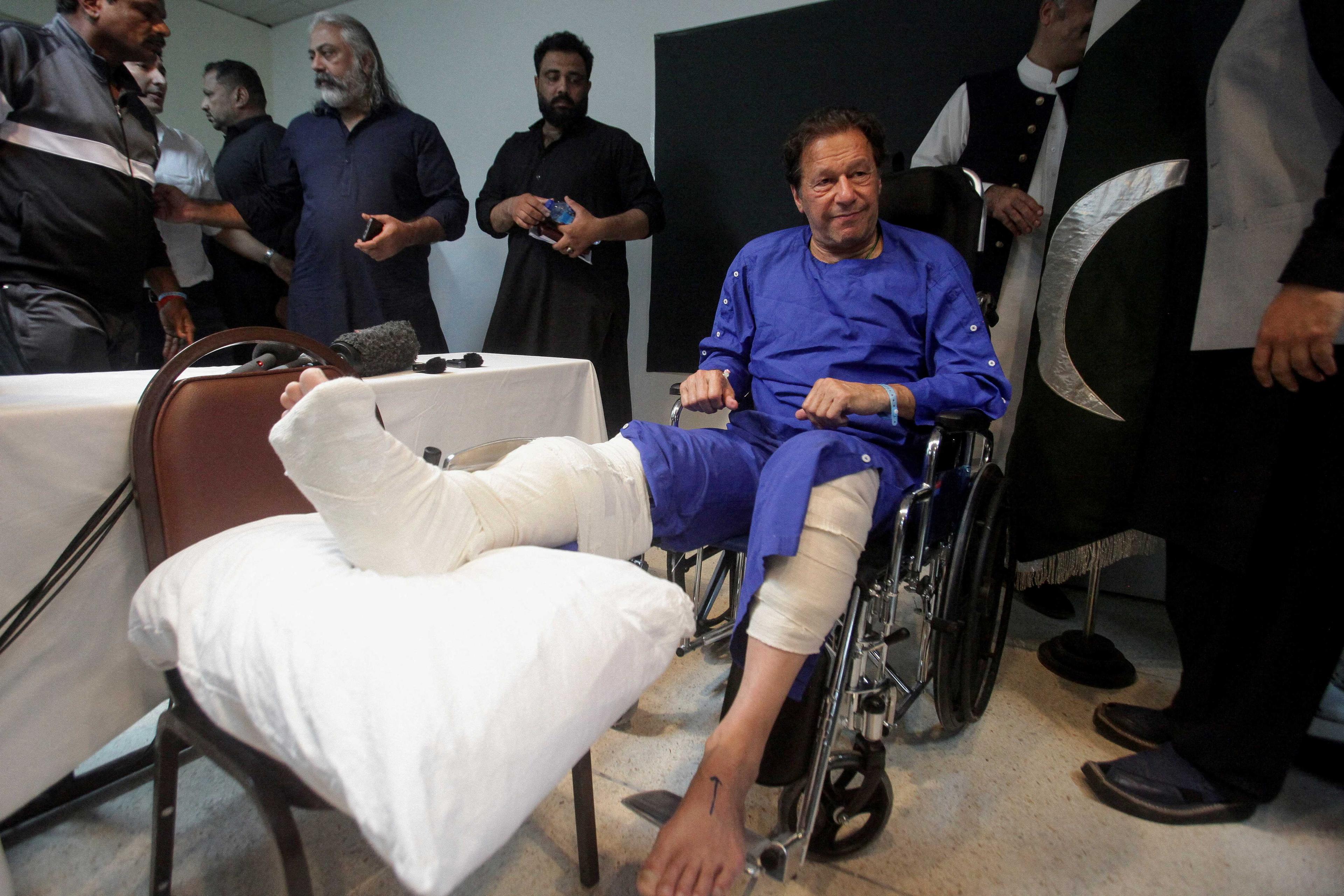 Former Pakistan's Prime Minister Imran Khan sits in a wheelchair after he was wounded following a shooting incident on a long march in Wazirabad, at the Shaukat Khanum Memorial Cancer Hospital & Research Centre in Lahore, Pakistan Nov 4. Photo: Reuters