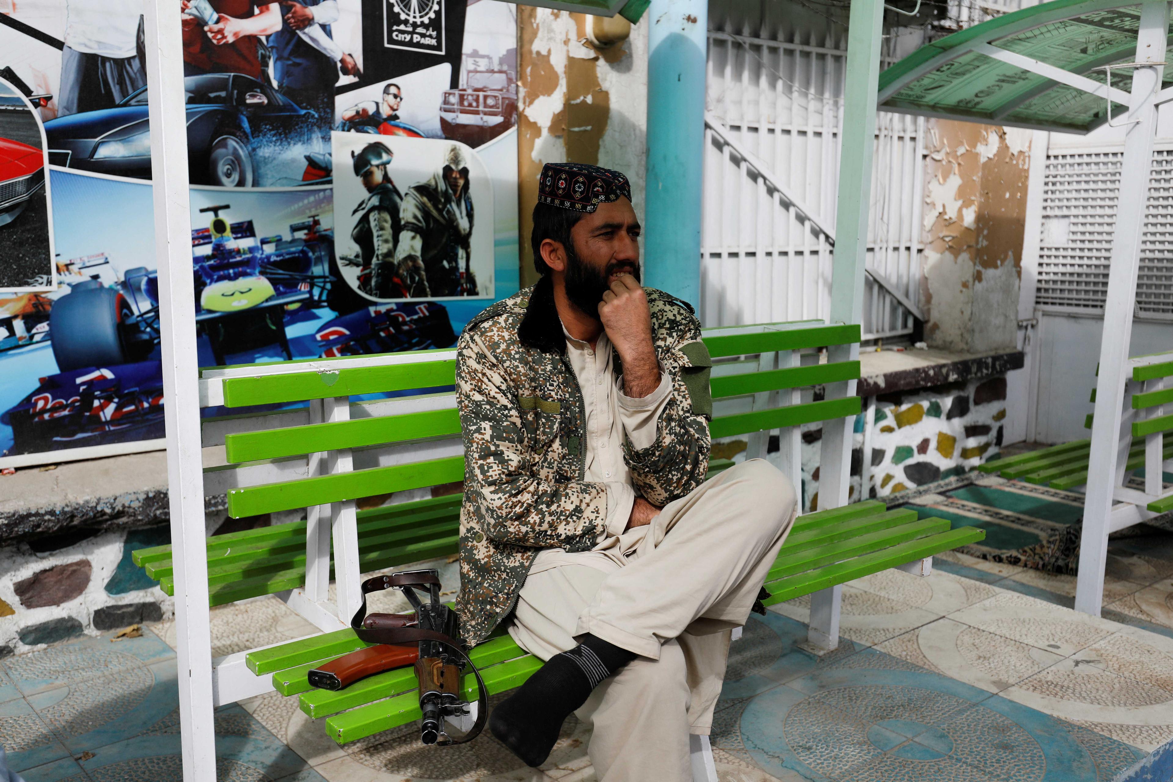 A Taliban fighter stands guard in an amusement park in Kabul, Afghanistan, Nov 9. Photo: Reuters