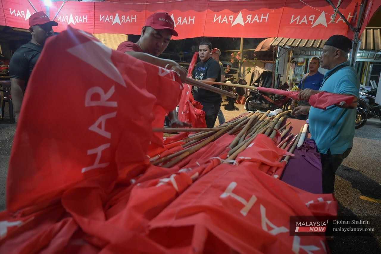 At the Pakatan Harapan operations centre in Taman Keramat Permai, flags are distributed to party workers. 
