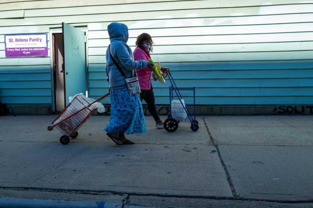 Residents receive food at the St Helena Pantry in the Bronx on Sept 28, in New York City. Photo: AFP