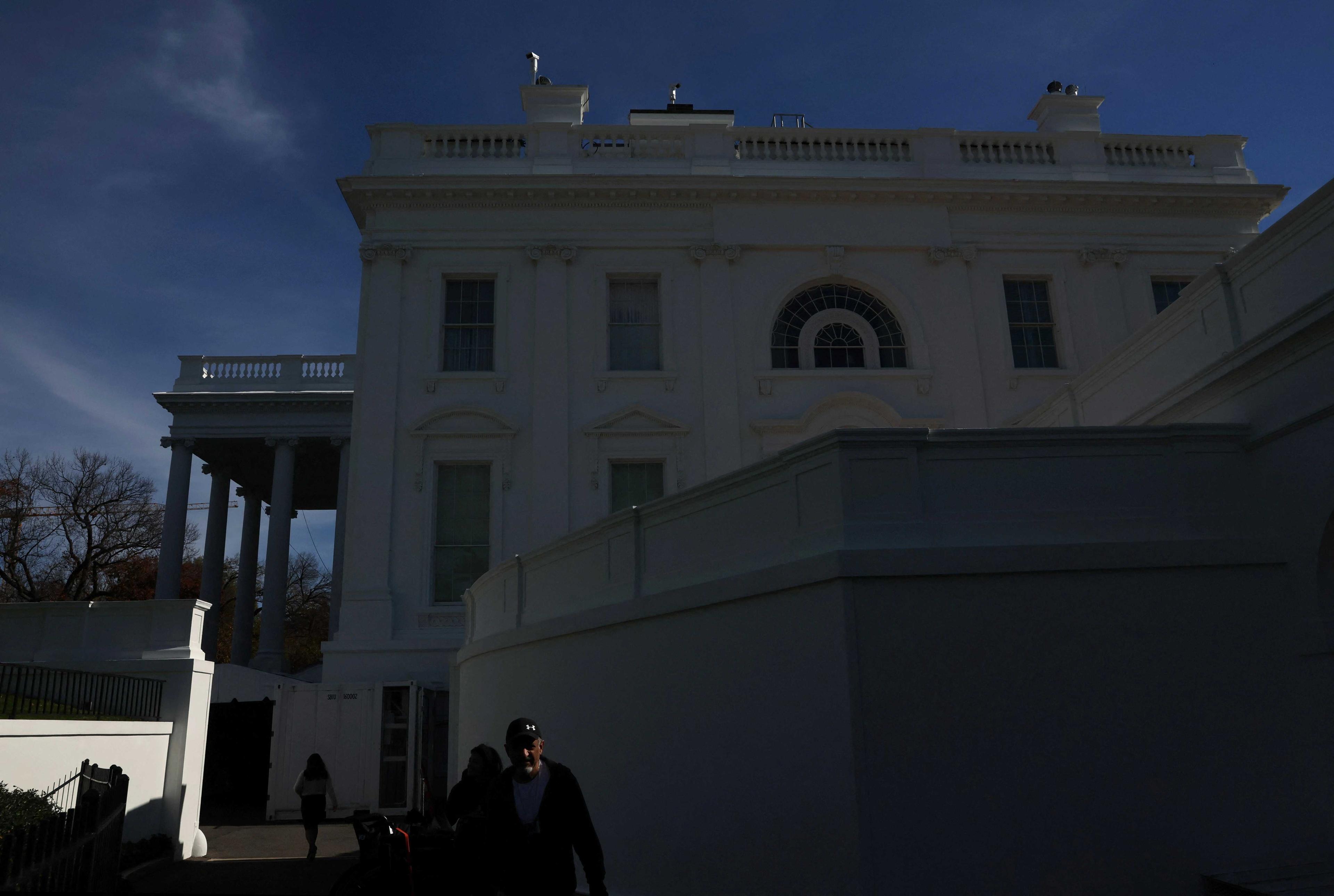 People walk on the White House grounds on election day in Washington, US, Nov 8. Photo: Reuters
