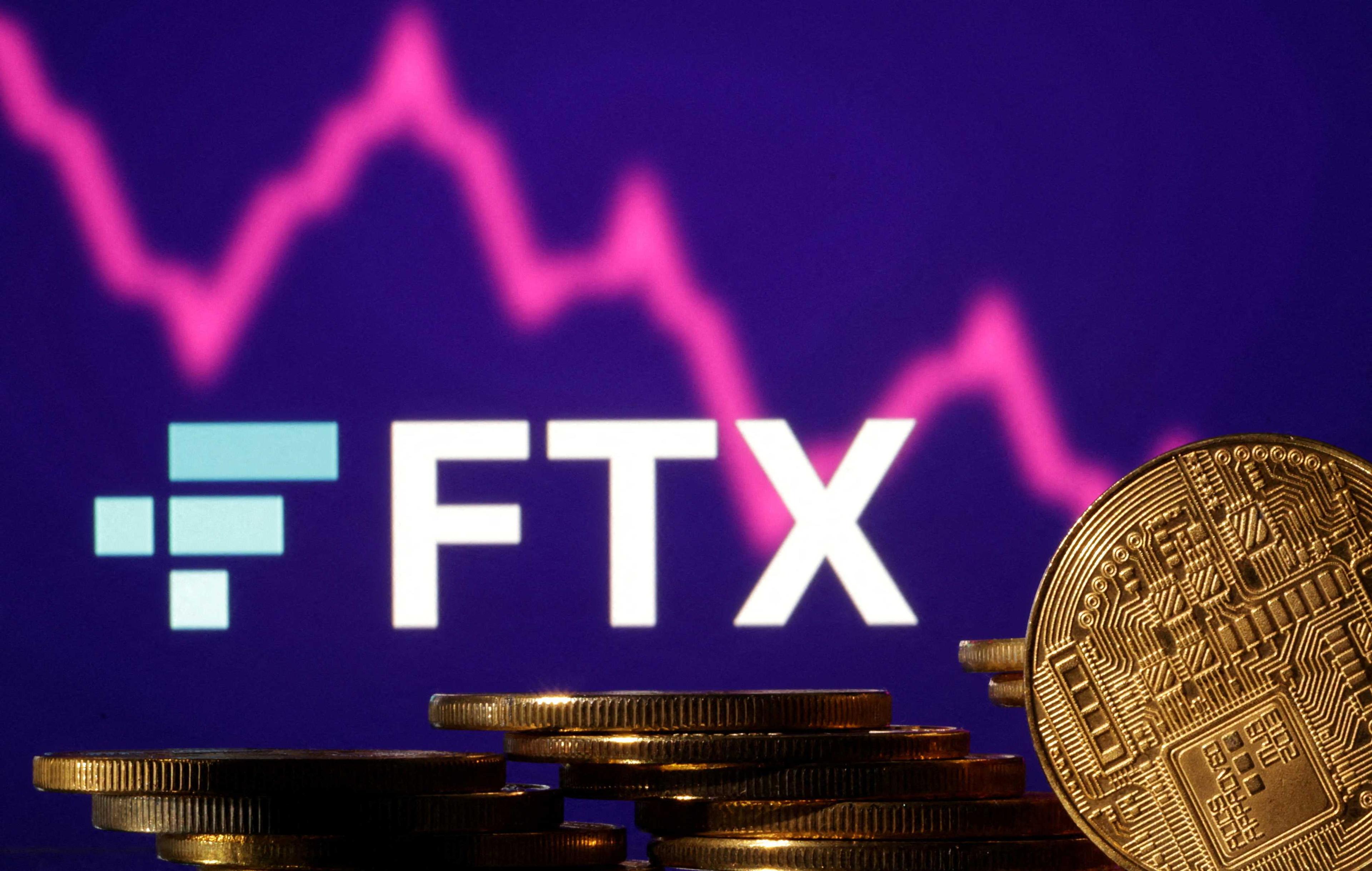 Representations of cryptocurrencies are seen in front of displayed FTX logo and decreasing stock graph in this illustration taken Nov 10. Photo: Reuters