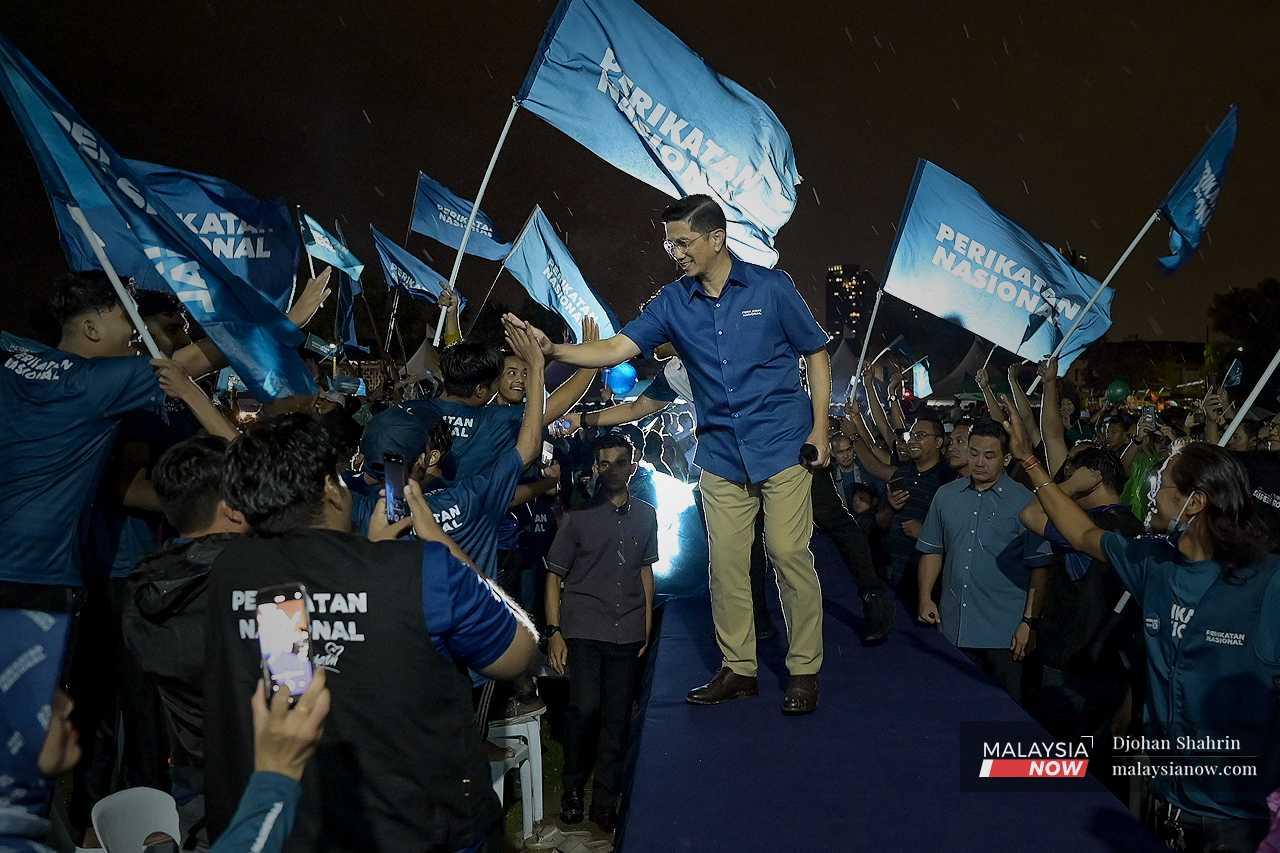 Perikatan Nasional information chief Mohamed Azmin Ali, who is defending his seat of Gombak, greets the crowd from the stage.
