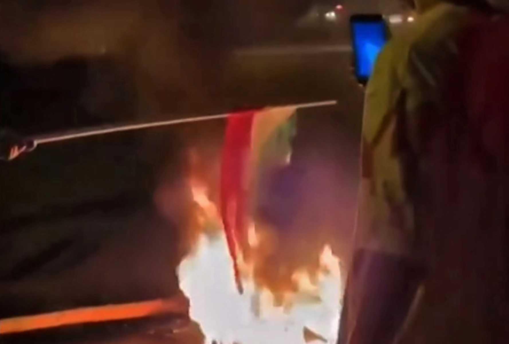 This grab taken from a UGC video made available on the ESN platform on Oct 12, shows protesters in the Iranian Kurdish city of Bukan, in Iran's west Azerbaijan province, burning a national flag. Photo: AFP